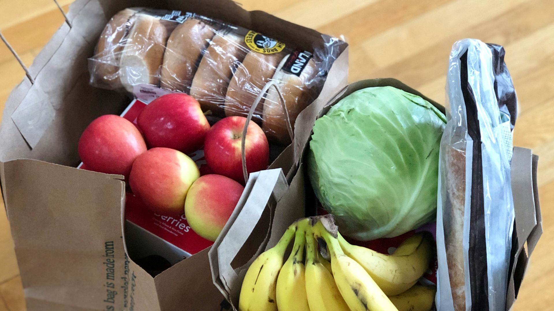 apples and bananas in brown cardboard box