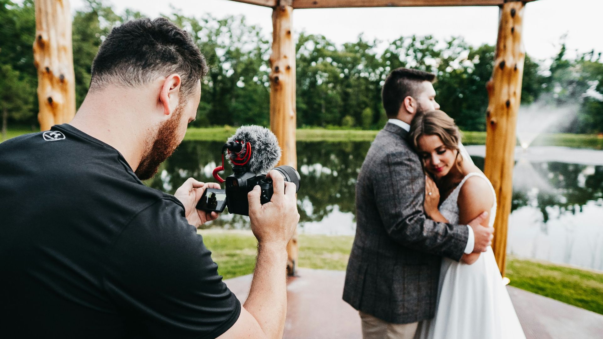 man in black t-shirt holding black dslr camera