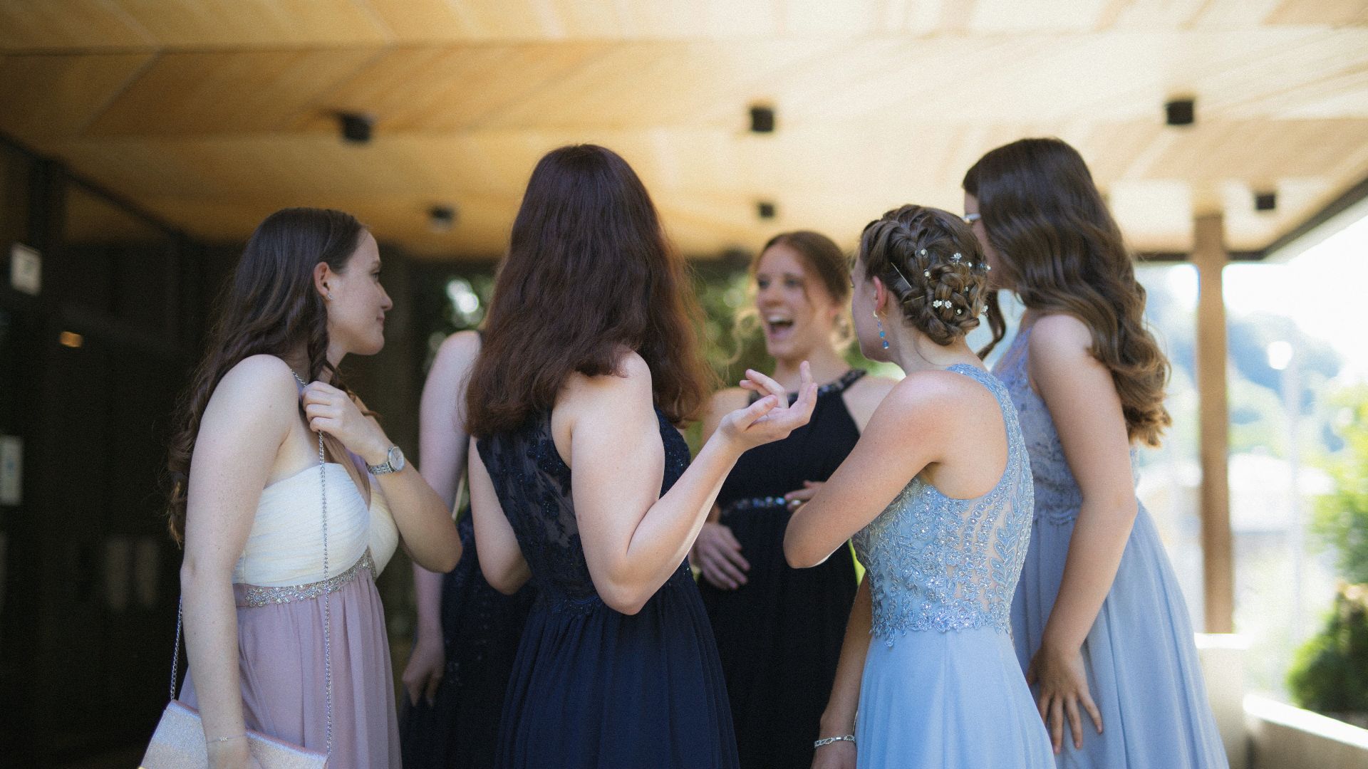 woman in black dress standing in front of woman in white dress