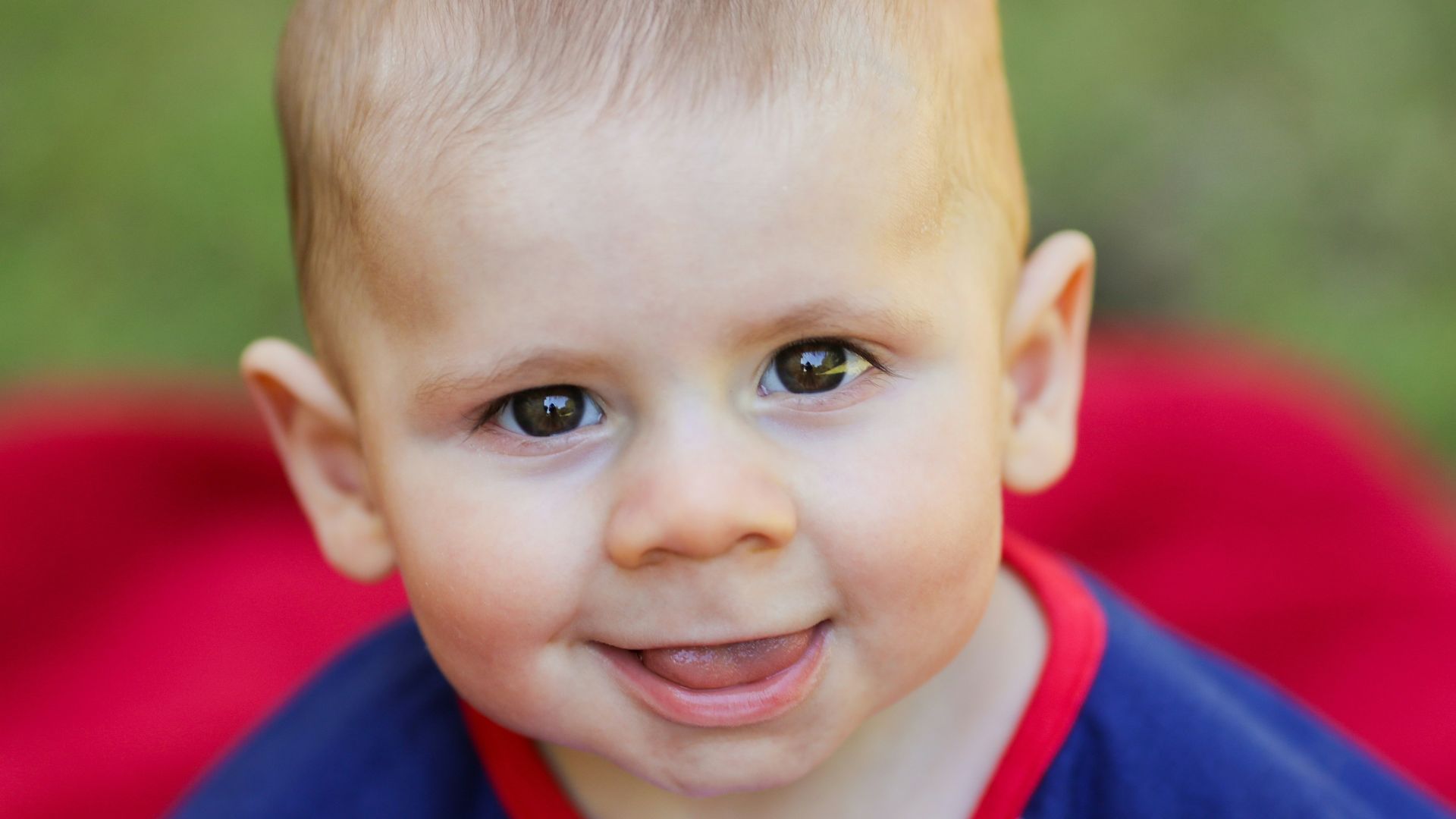 boy in blue and white striped shirt smiling