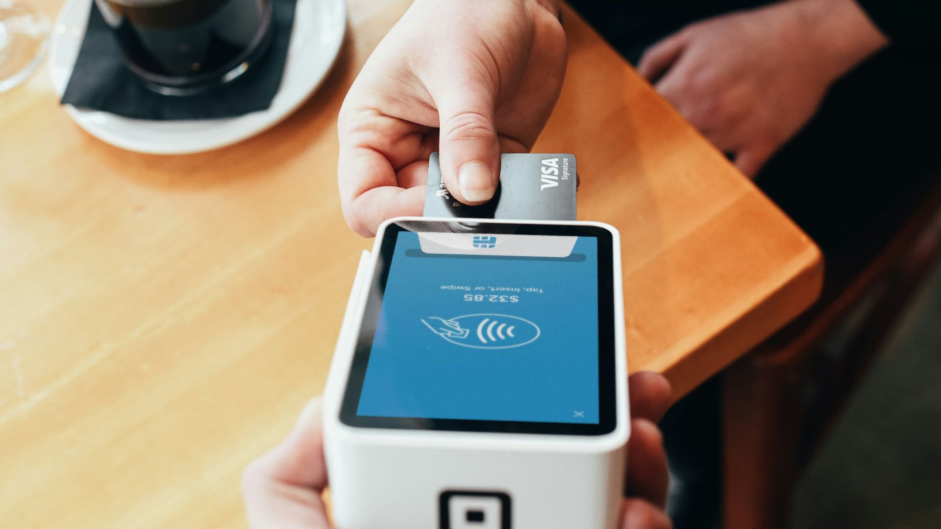 person holding credit card swipe machine