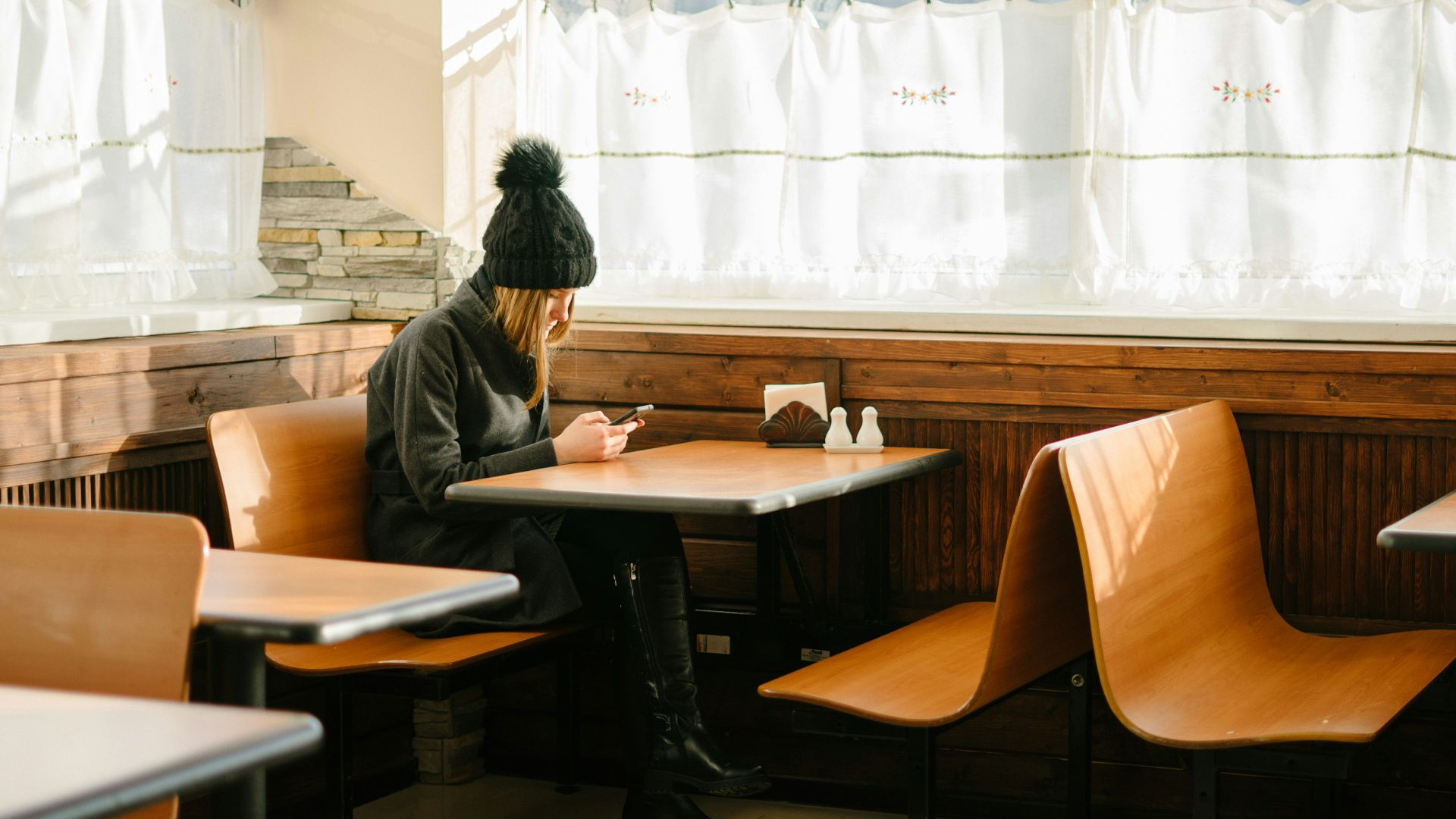 person sitting in front of brown wooden table