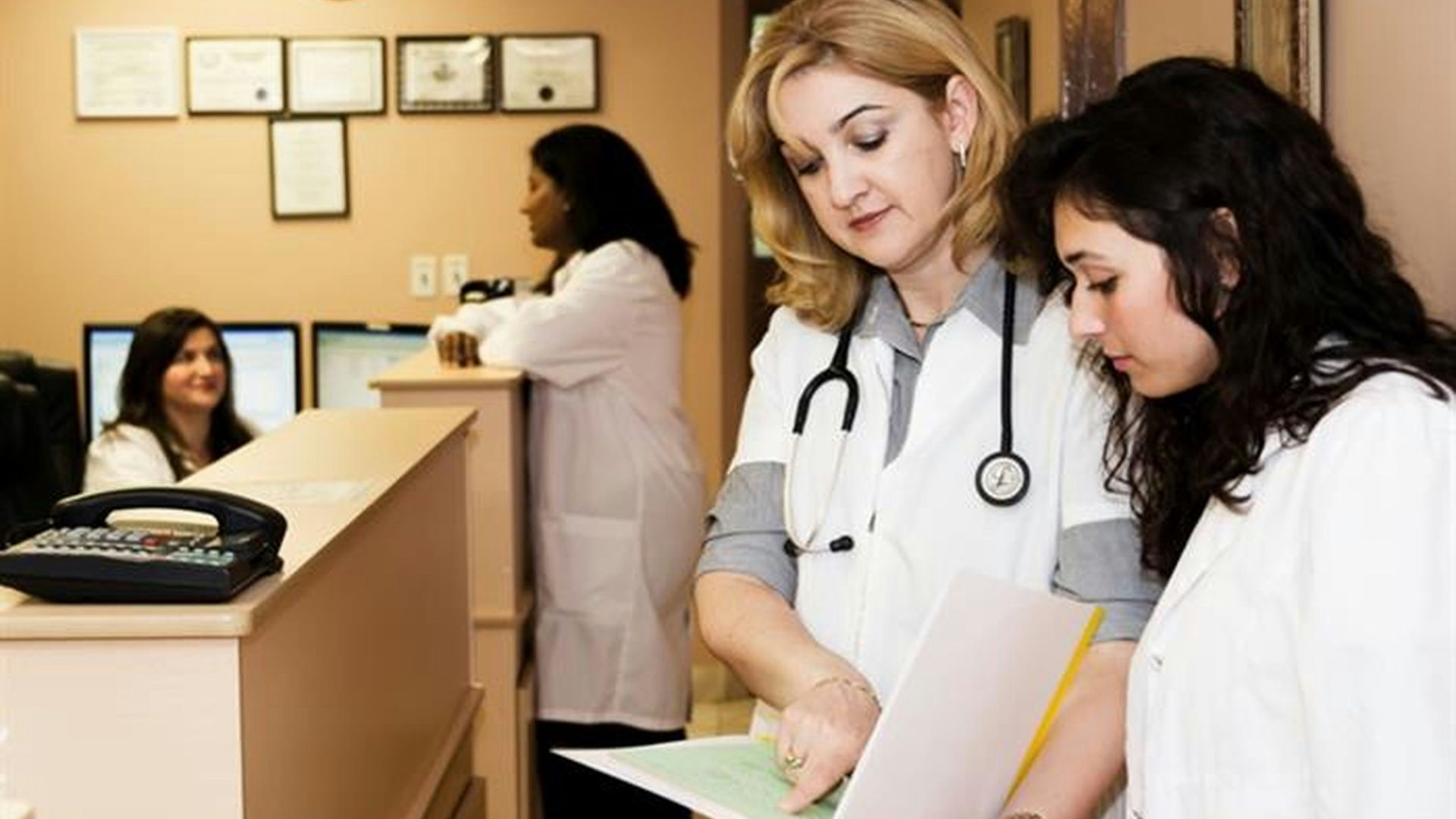 woman in white long sleeve shirt holding white printer paper