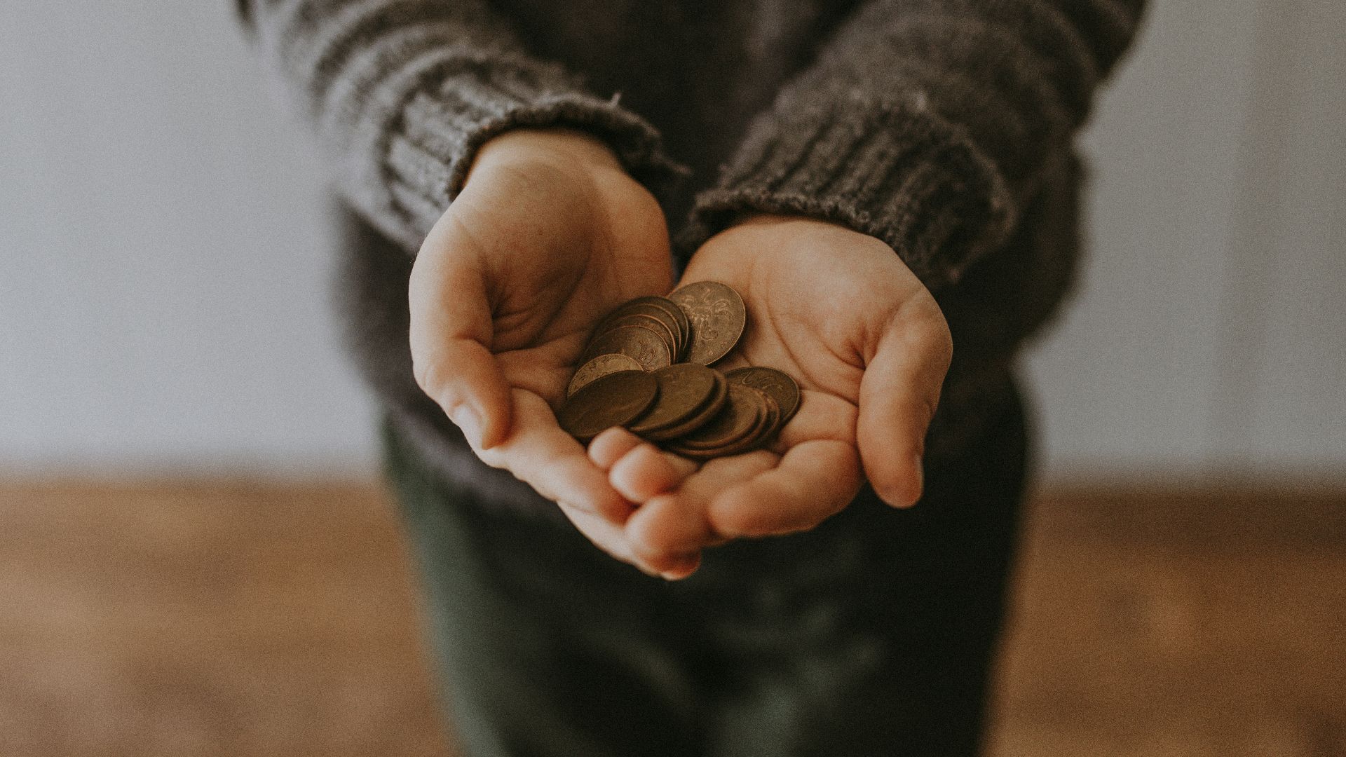copper-colored coins on in person's hands
