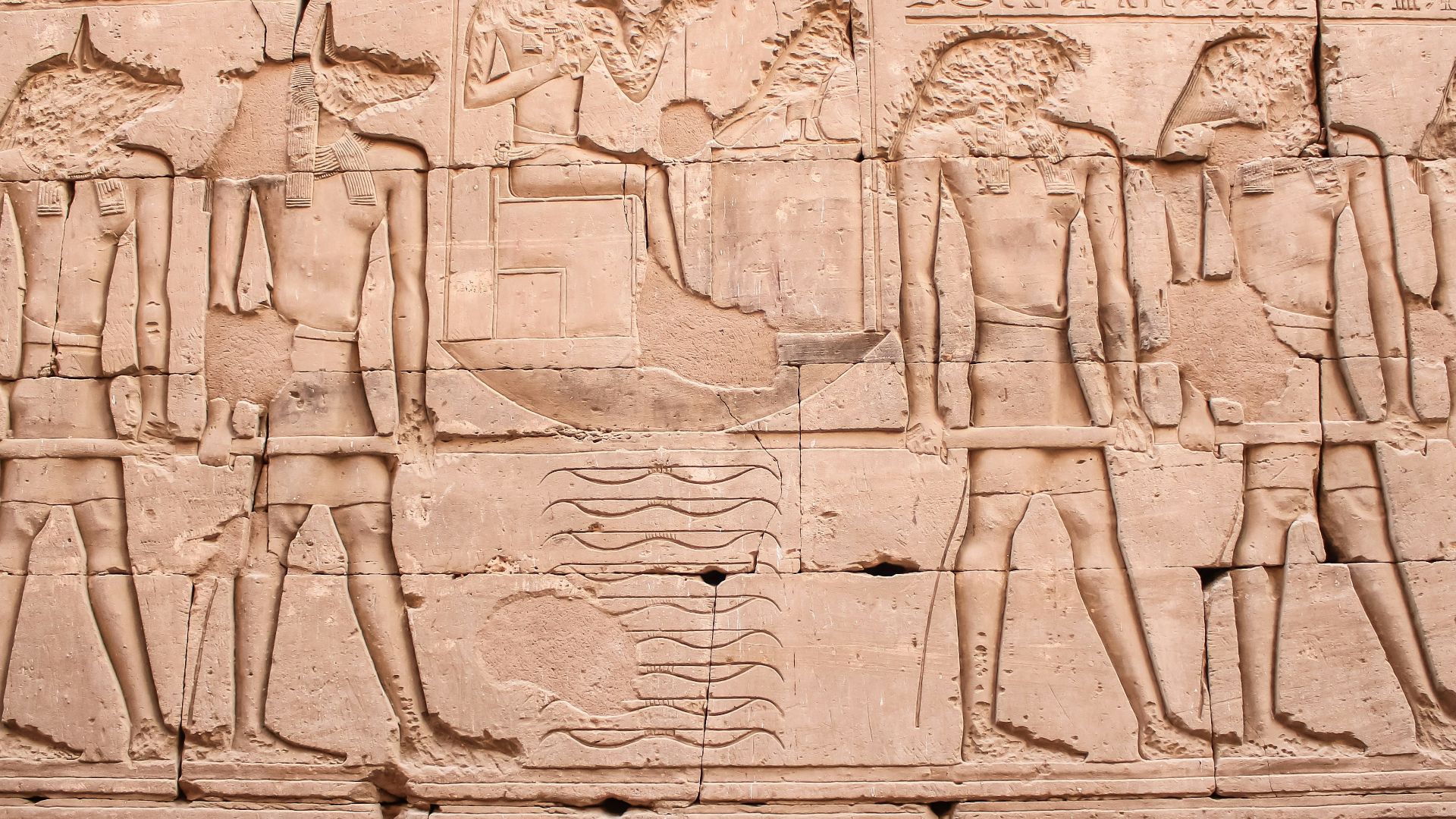 a wall with a bunch of ancient egyptian art on it