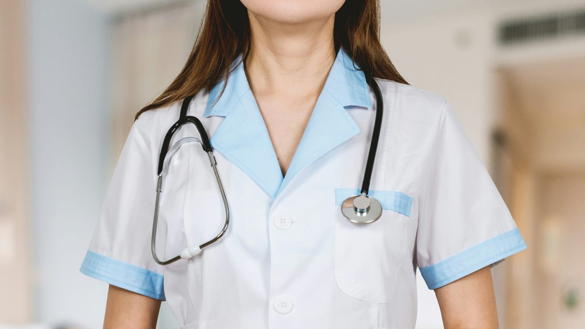 woman in white button up shirt and blue stethoscope