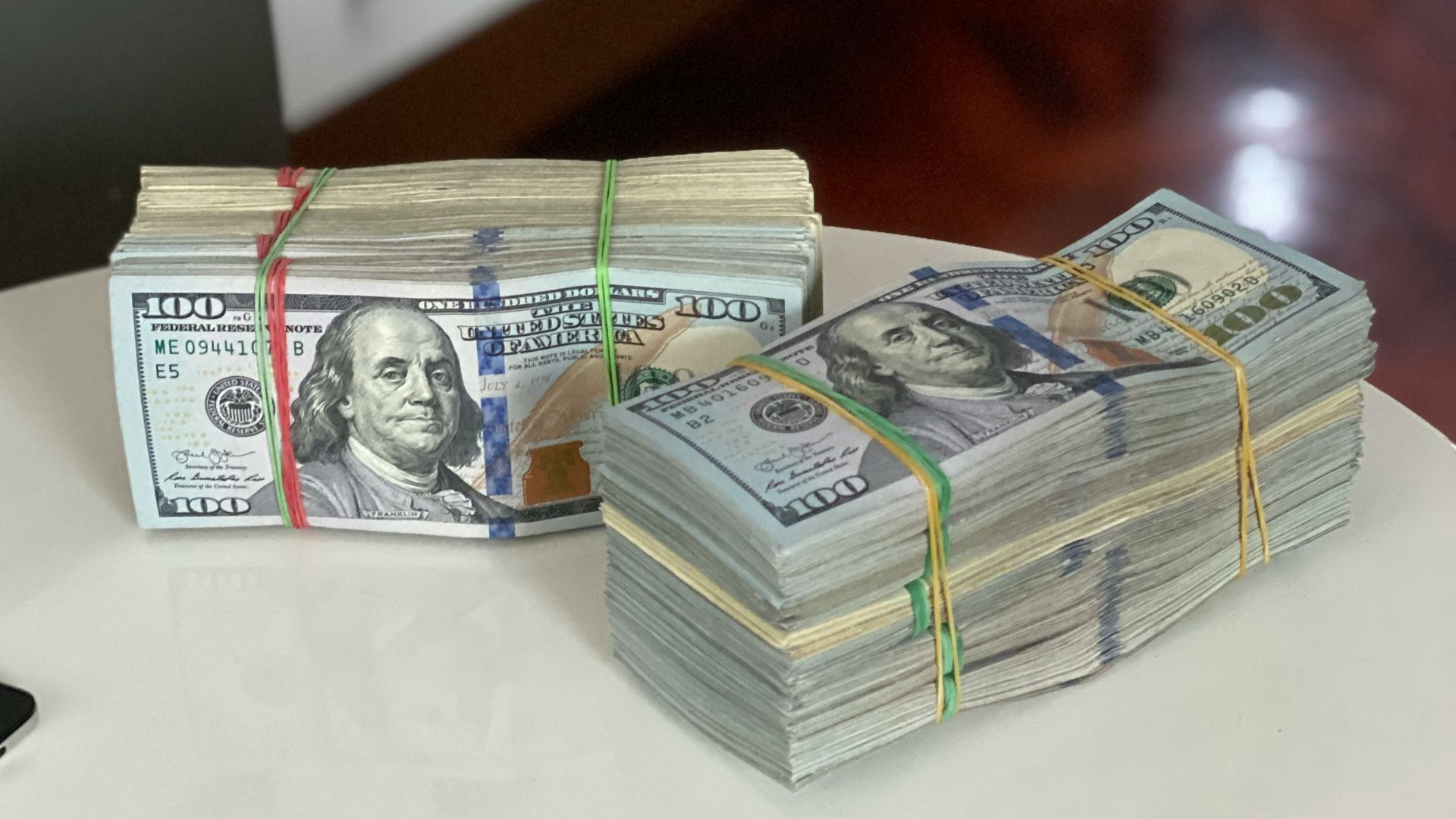 a stack of money sitting on top of a white table