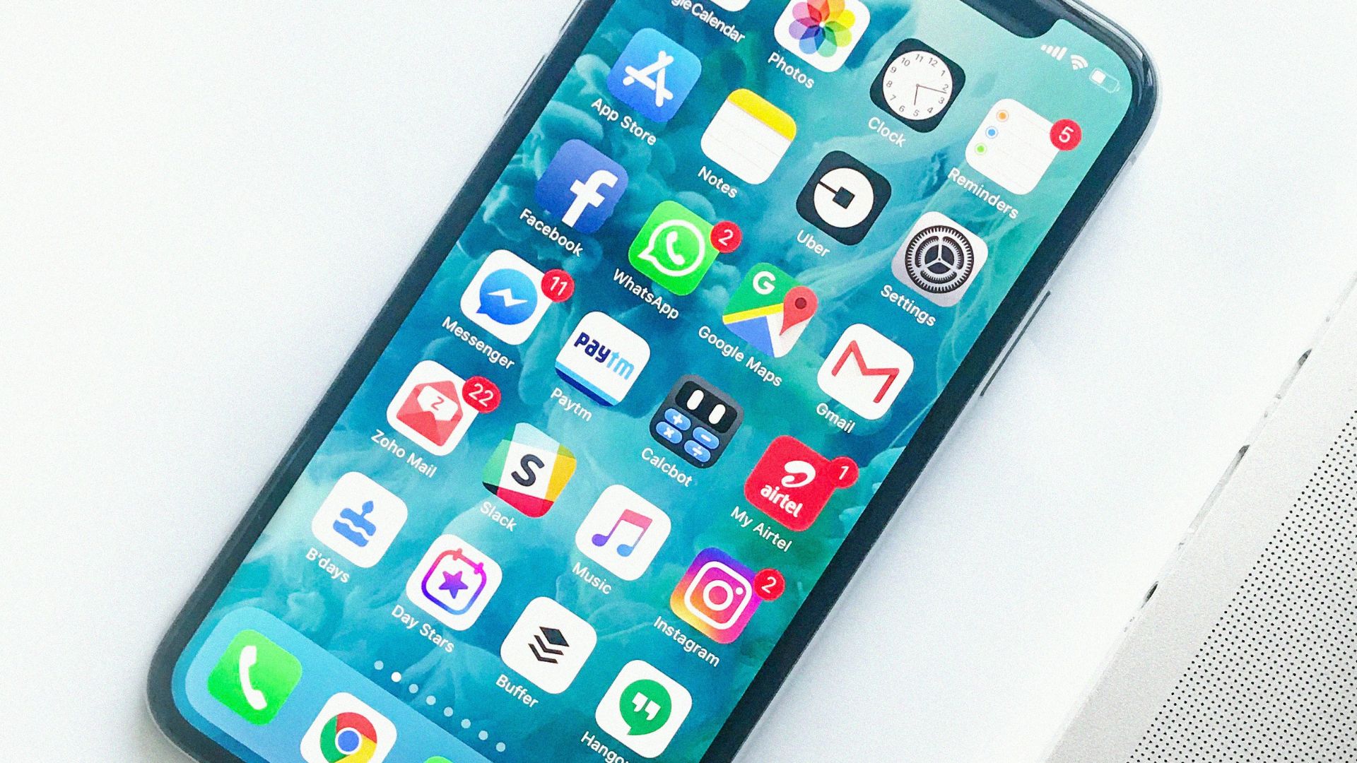 white smartphone near laptop