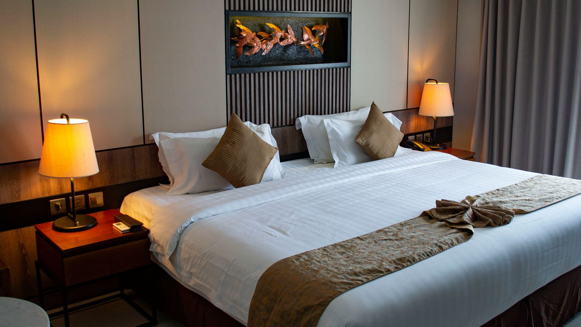 white bed linen with throw pillows