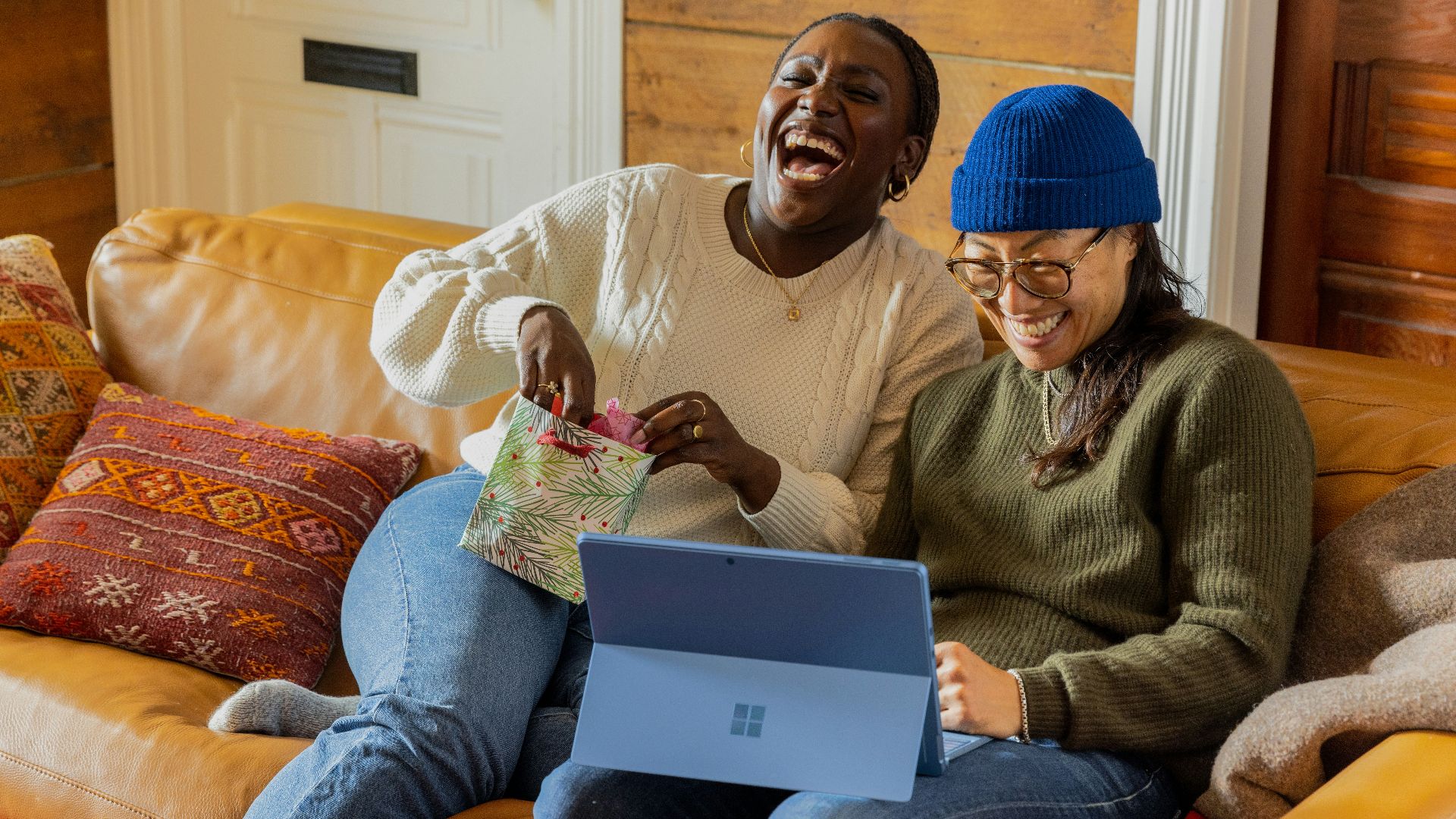 a person sitting on a couch with a laptop