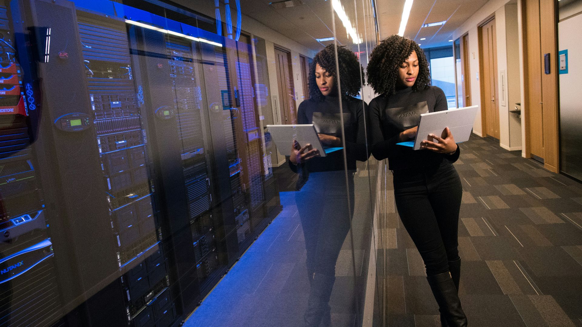 woman in black top using Surface laptop