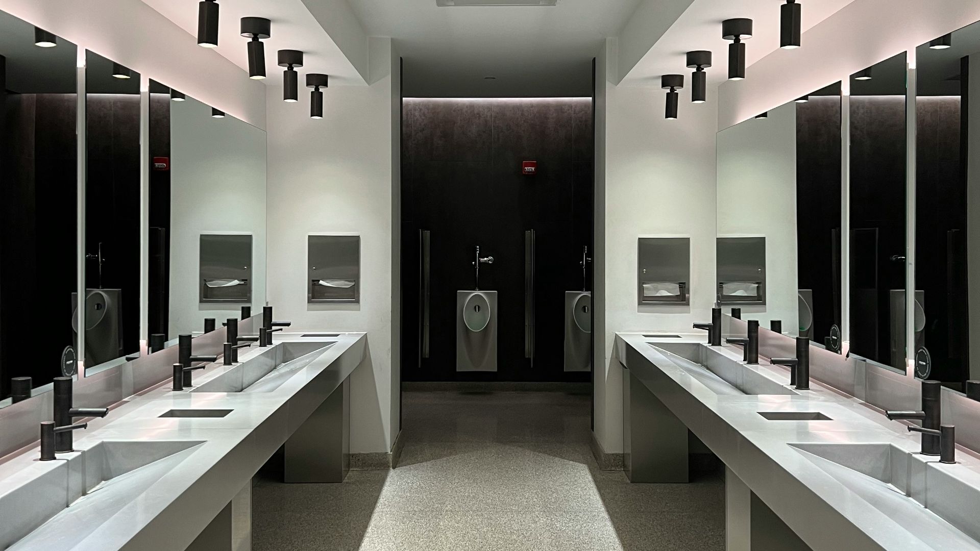 a large bathroom with sinks and mirrors