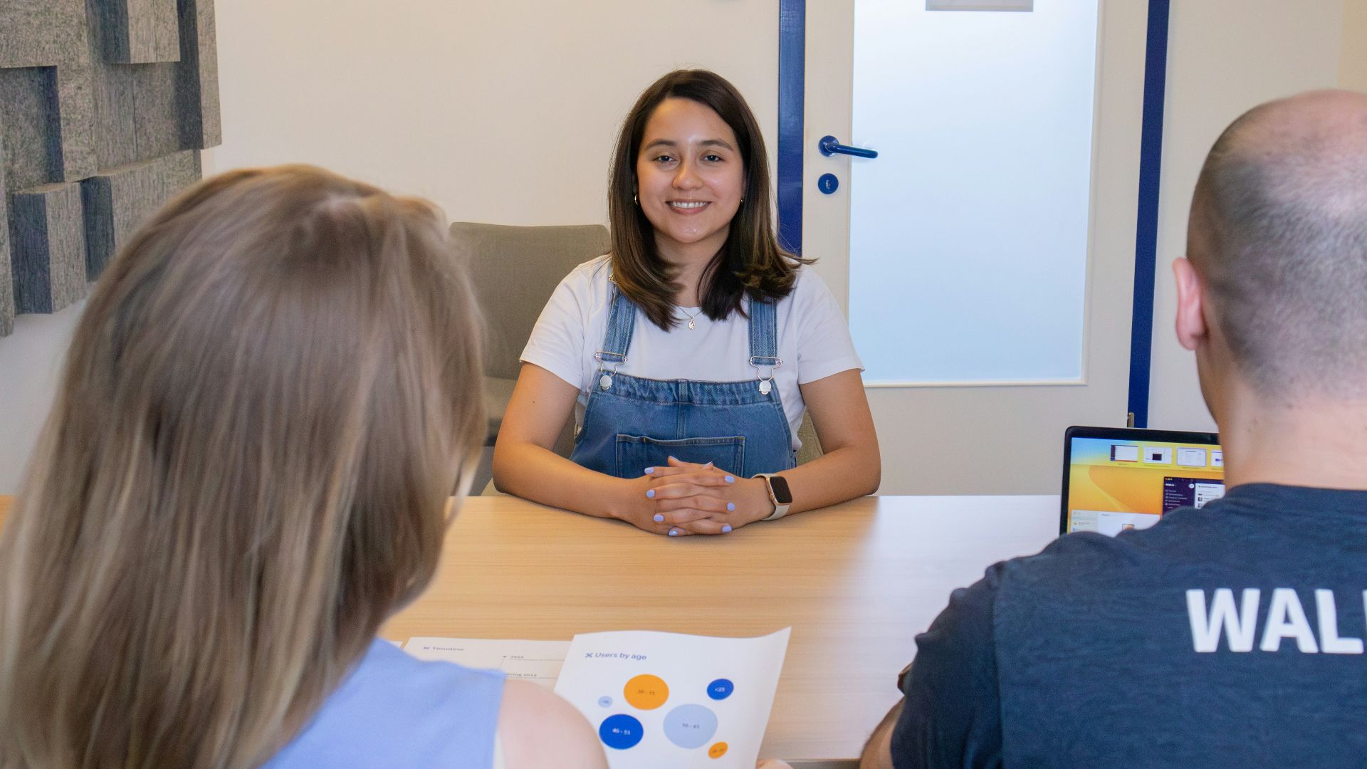 a woman sitting at a table in front of a man