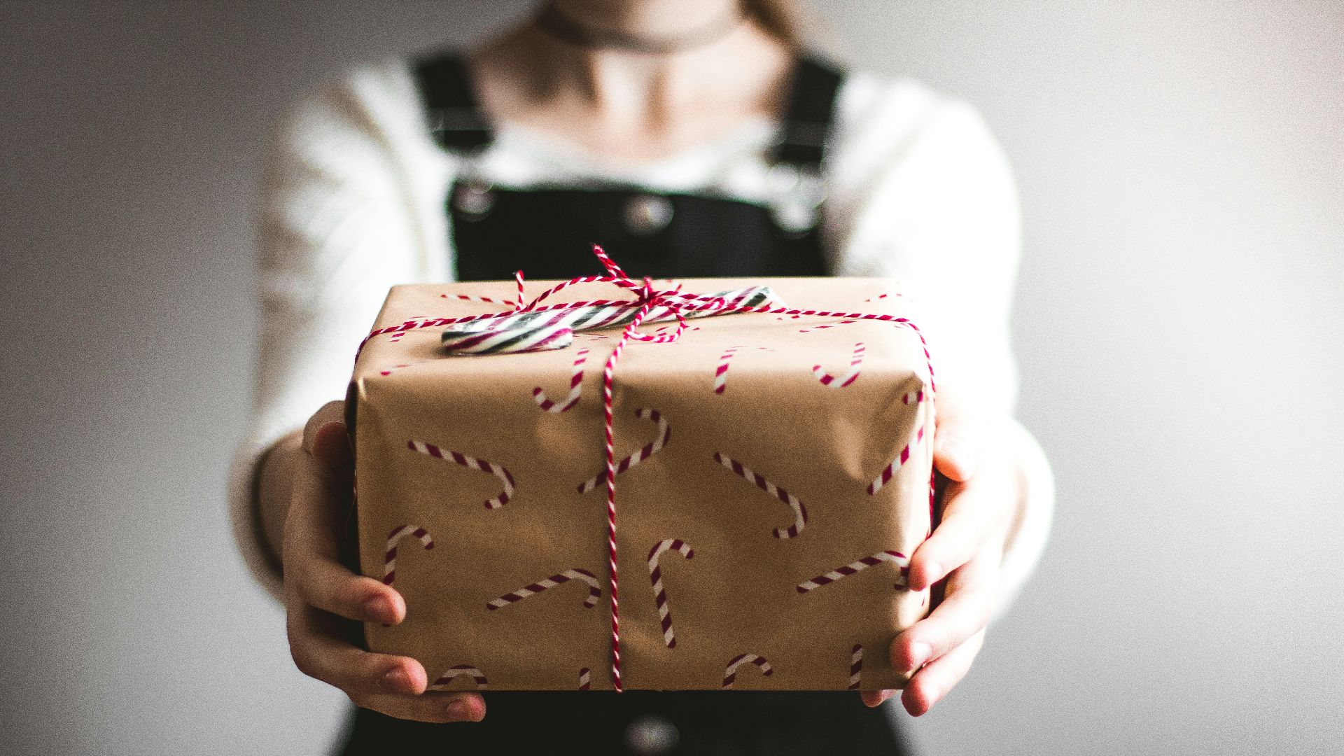person showing brown gift box