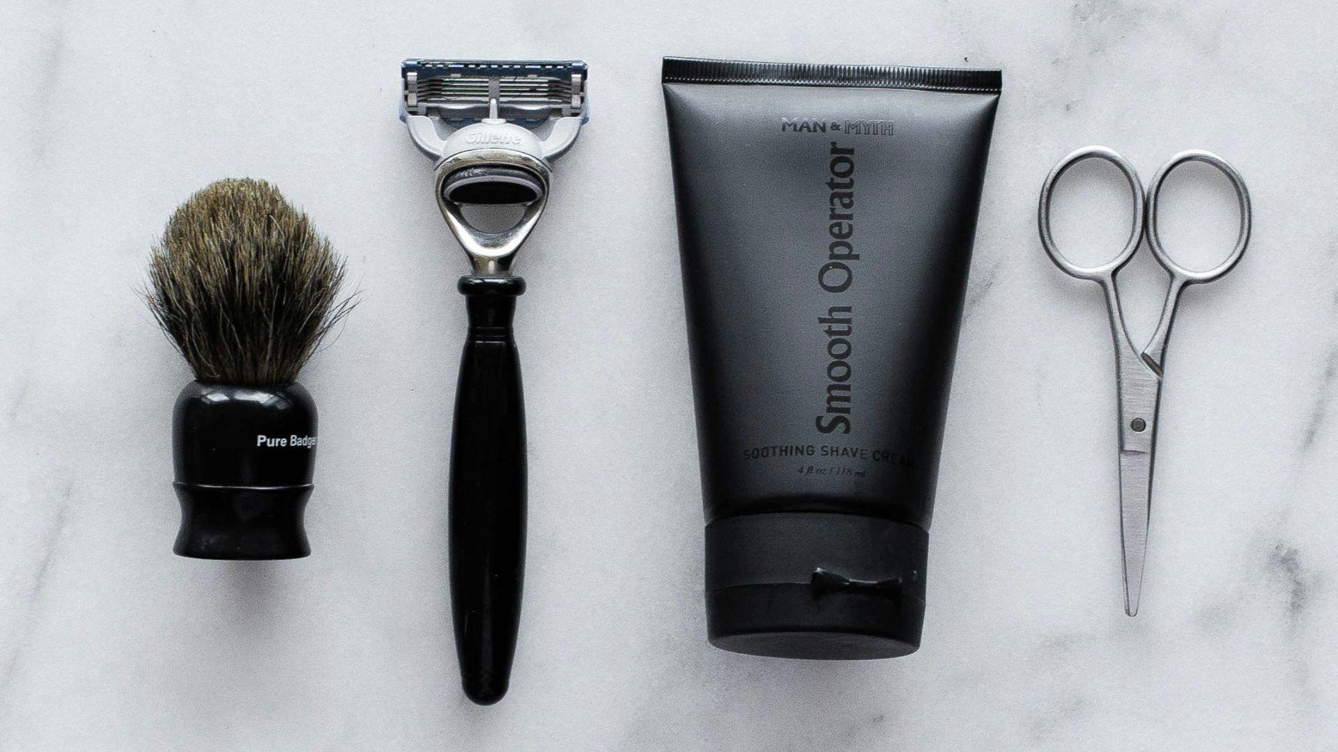 black and silver hair brush beside black soft tube