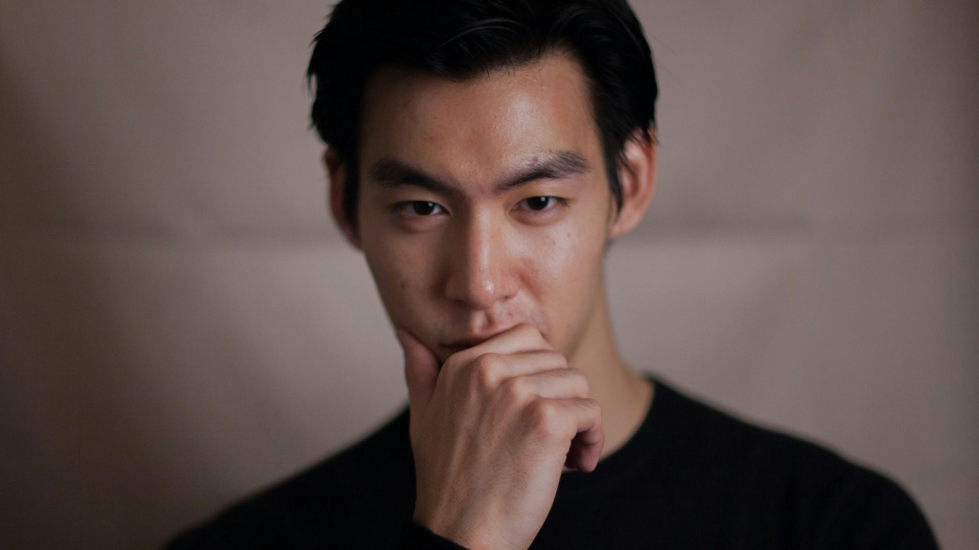 man touching his chin with right hand