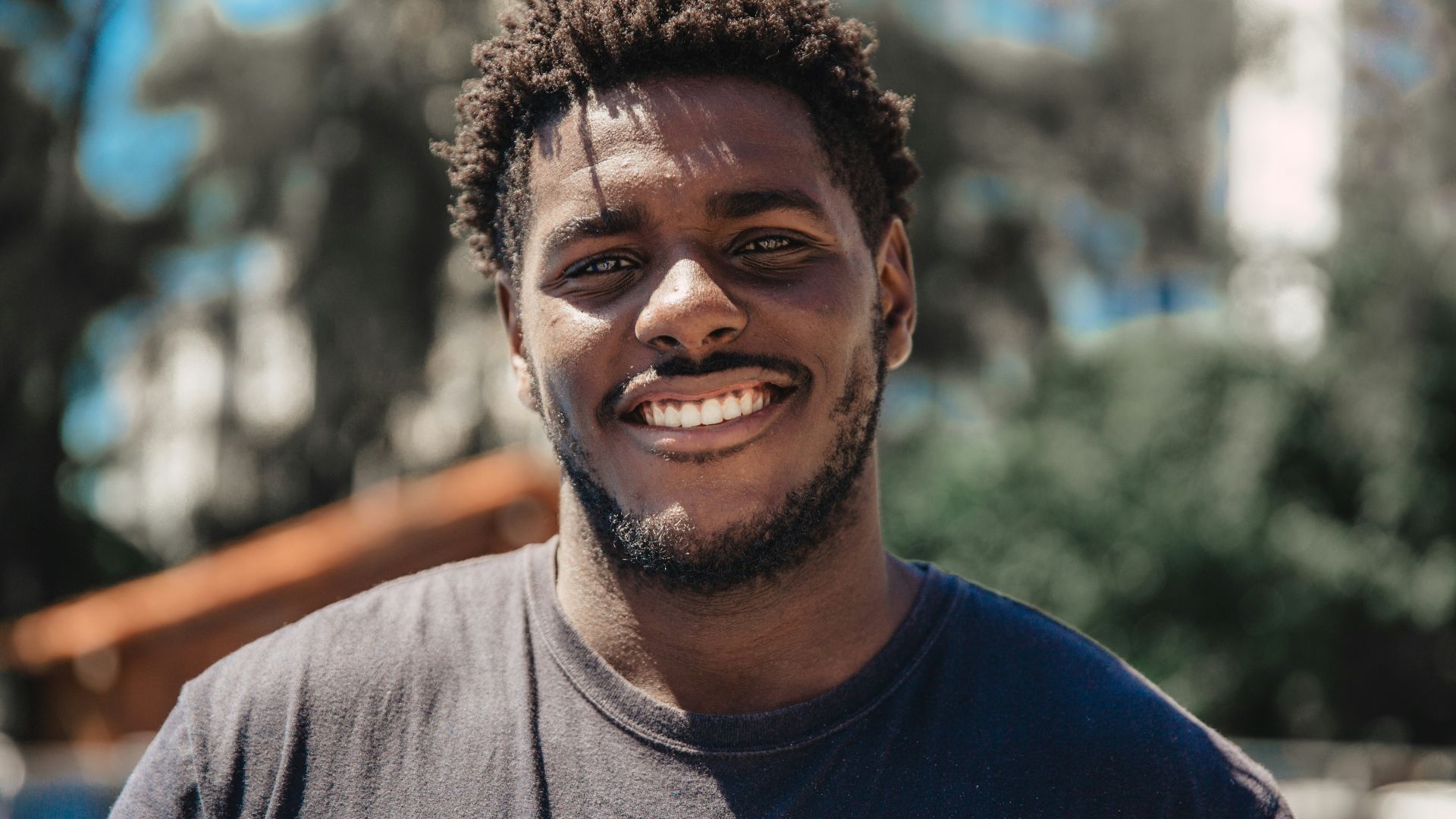 selective focus of man smiling during daytime
