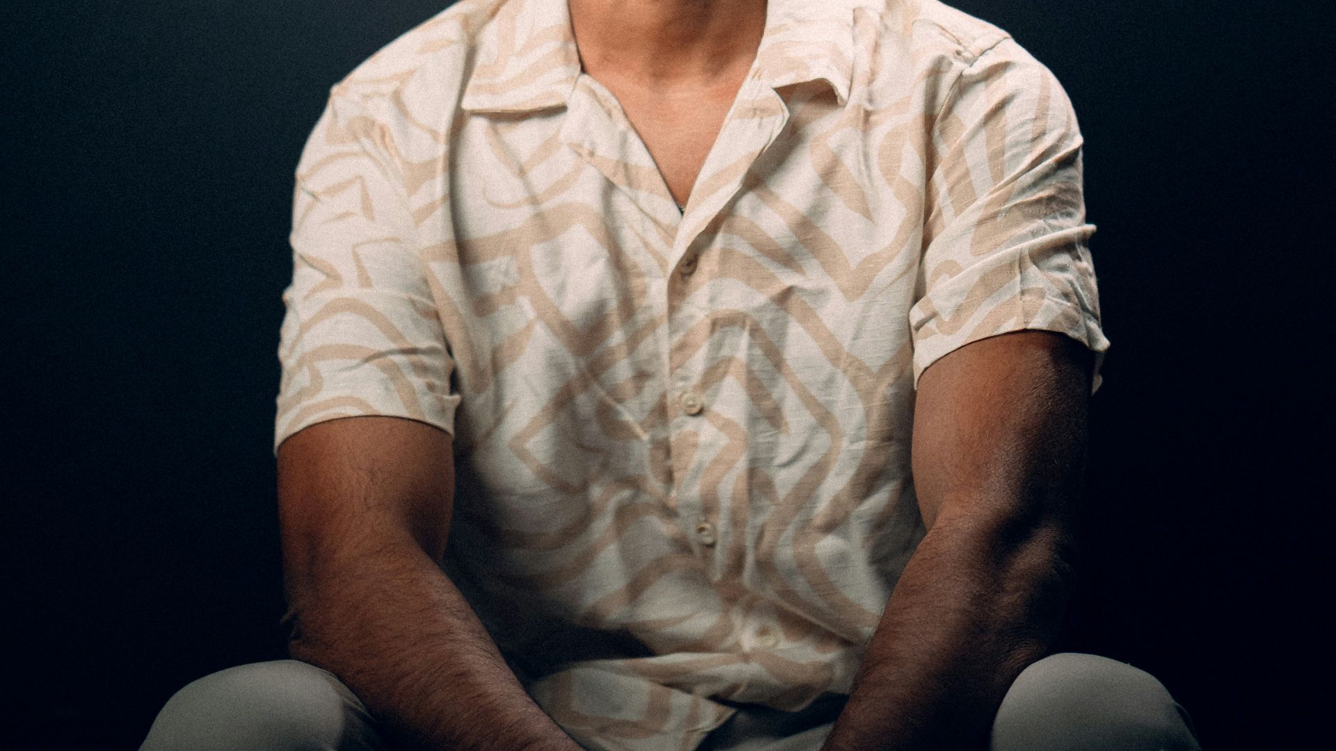 a man sitting on the ground with his eyes closed