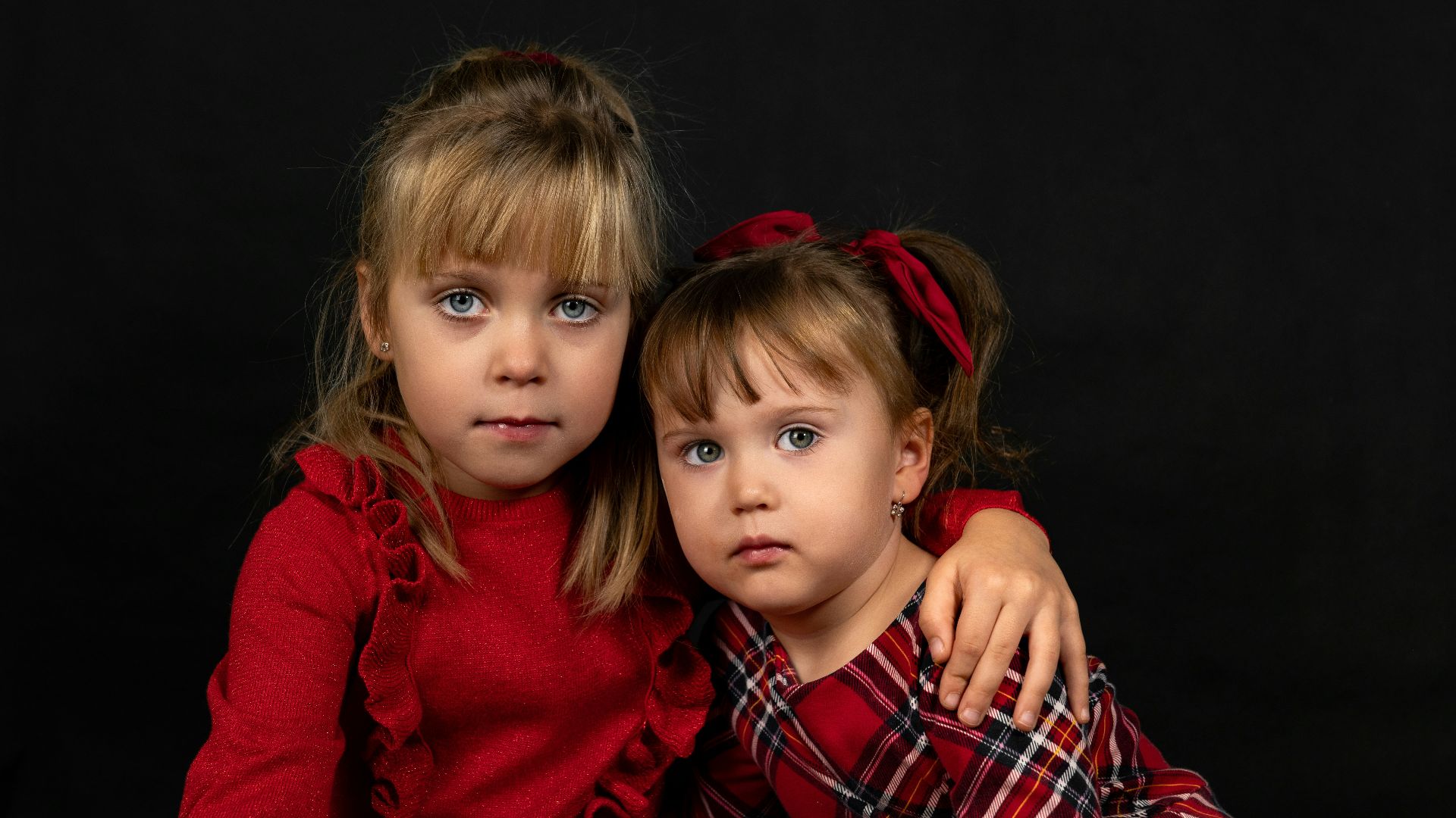 two little girls are posing for a picture