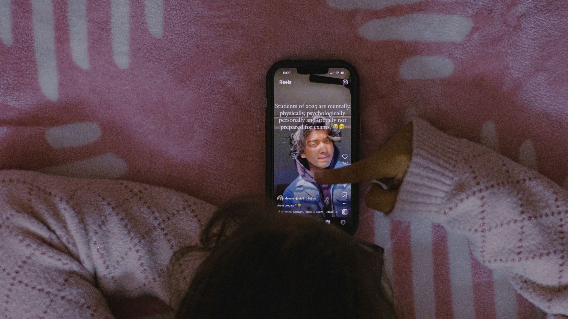 a person laying in bed with a cell phone