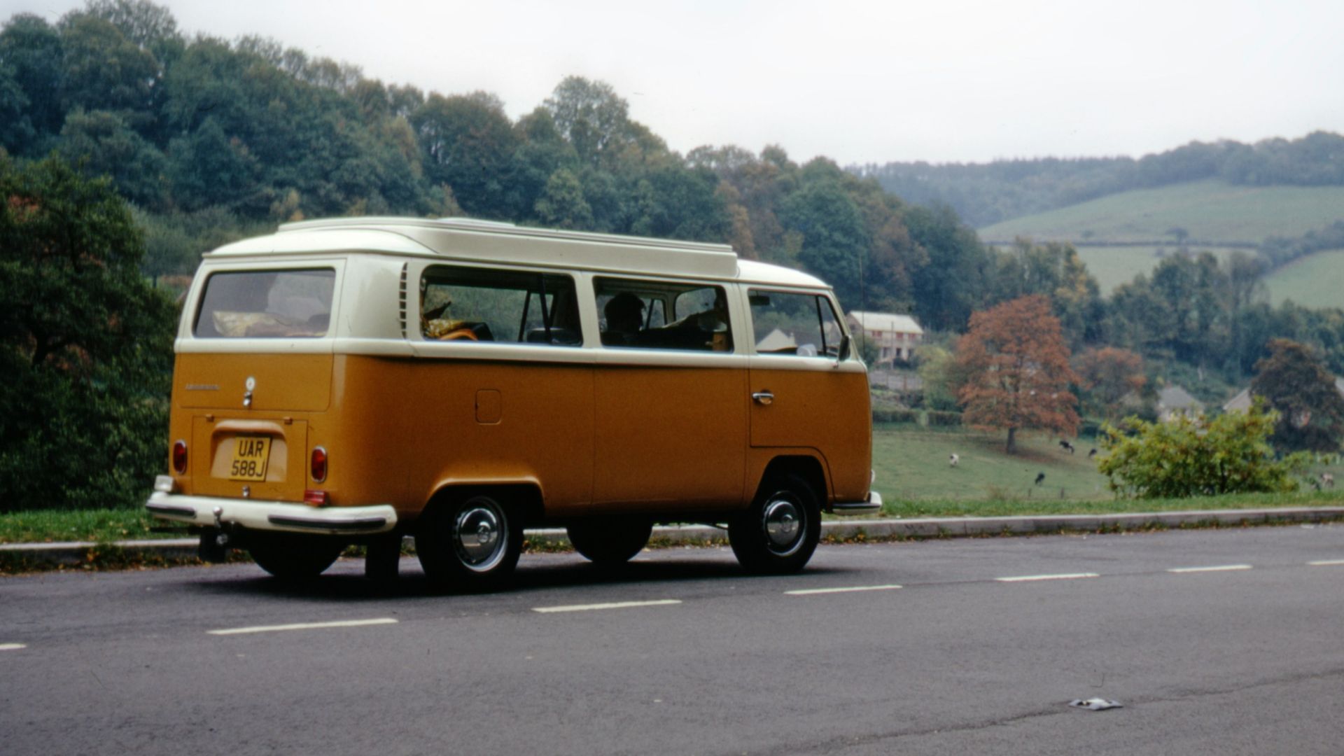 orange and white volkswagen t-2 on road during daytime