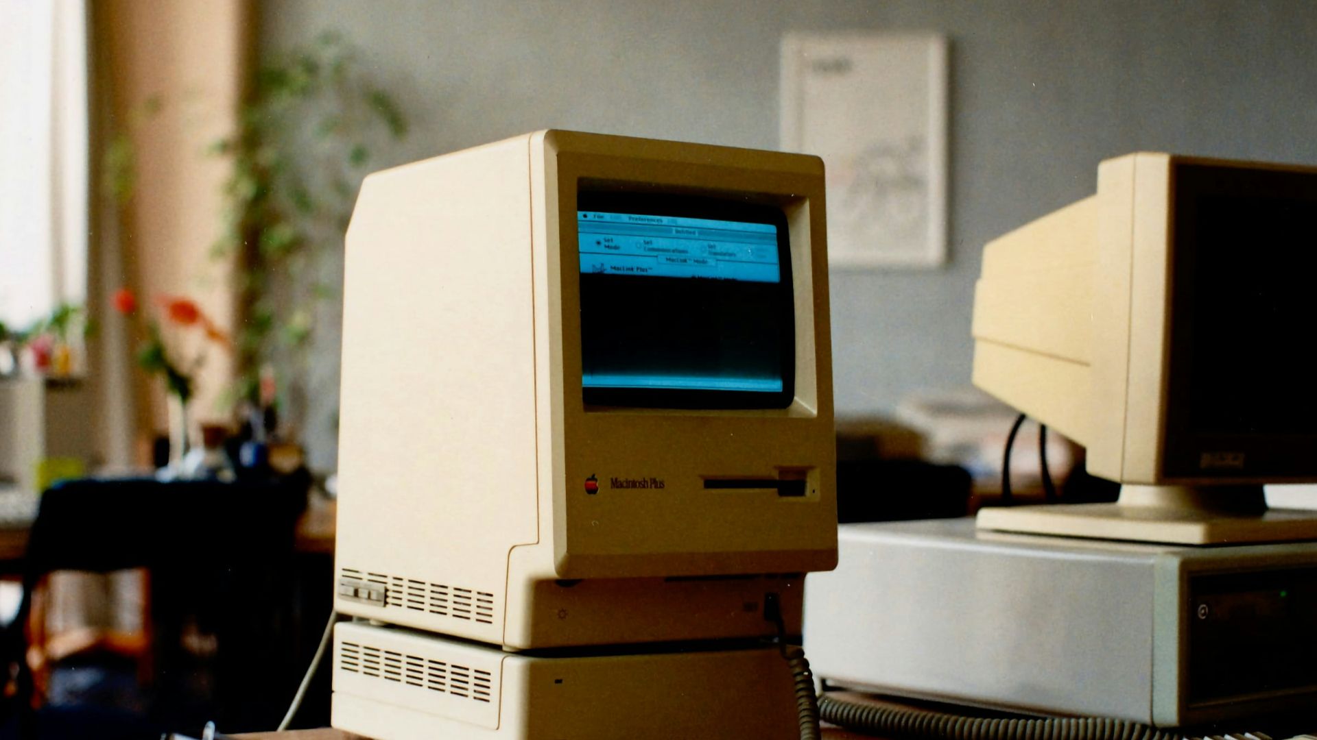 a computer sitting on top of a wooden desk