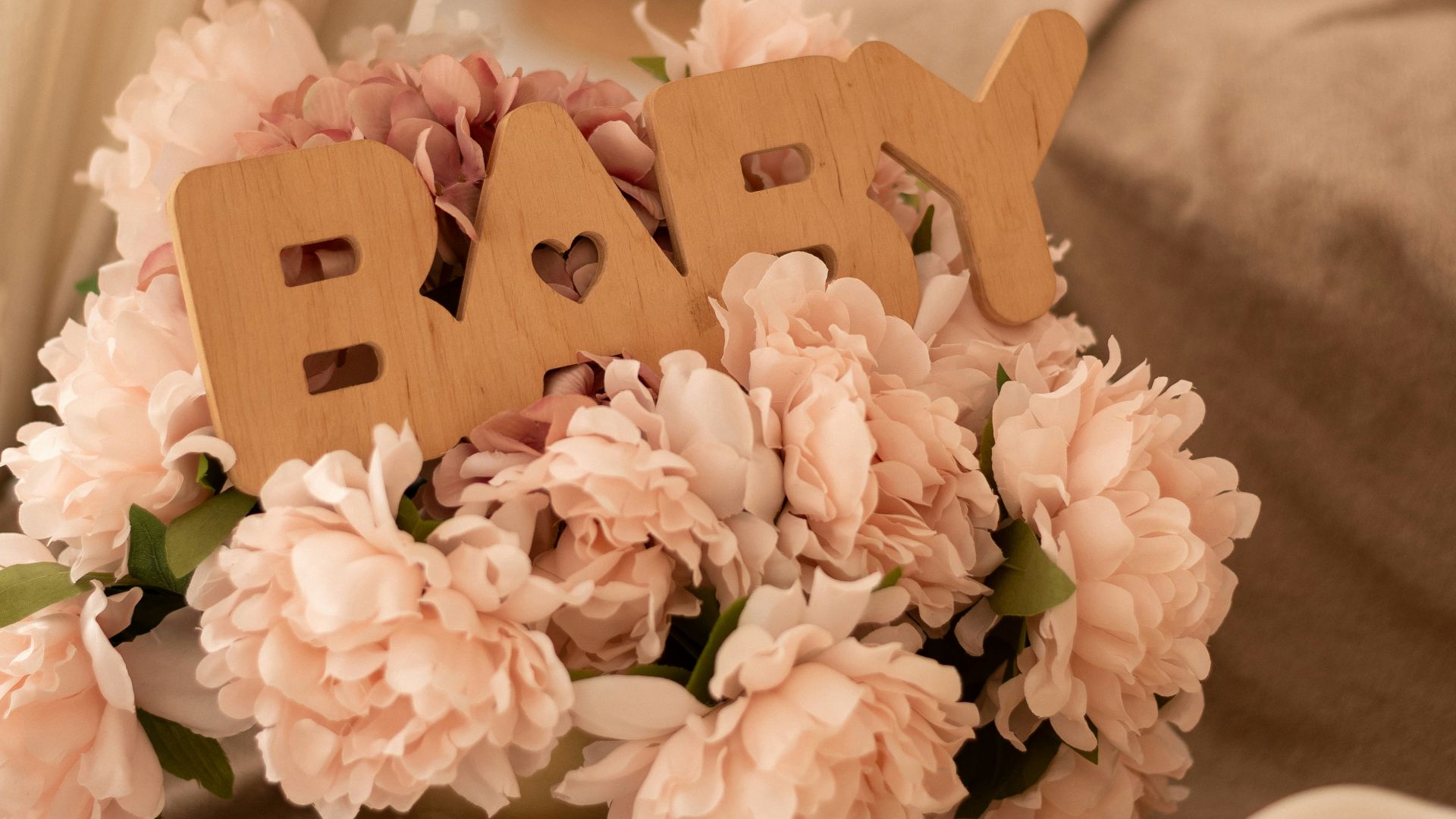 Baby shower decoration featuring flowers and candles.