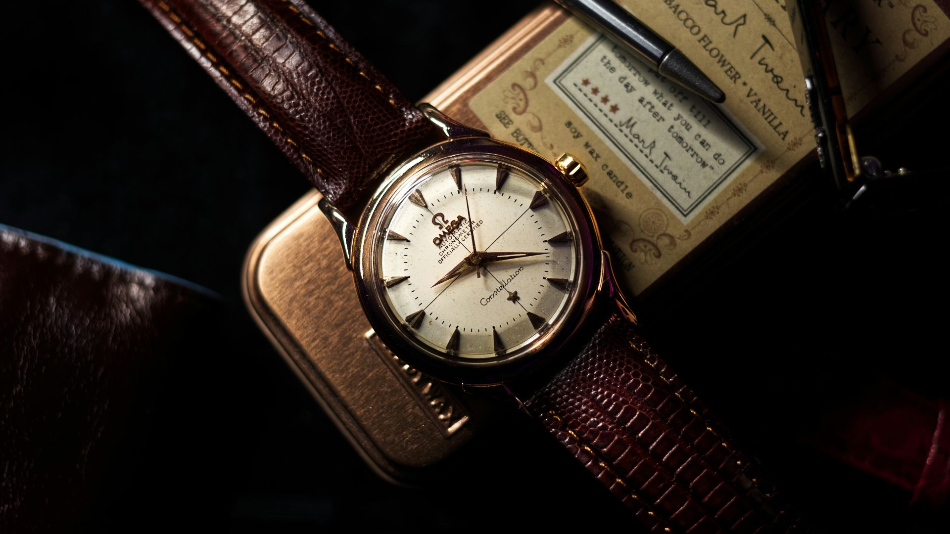 a watch sitting on top of a brown case