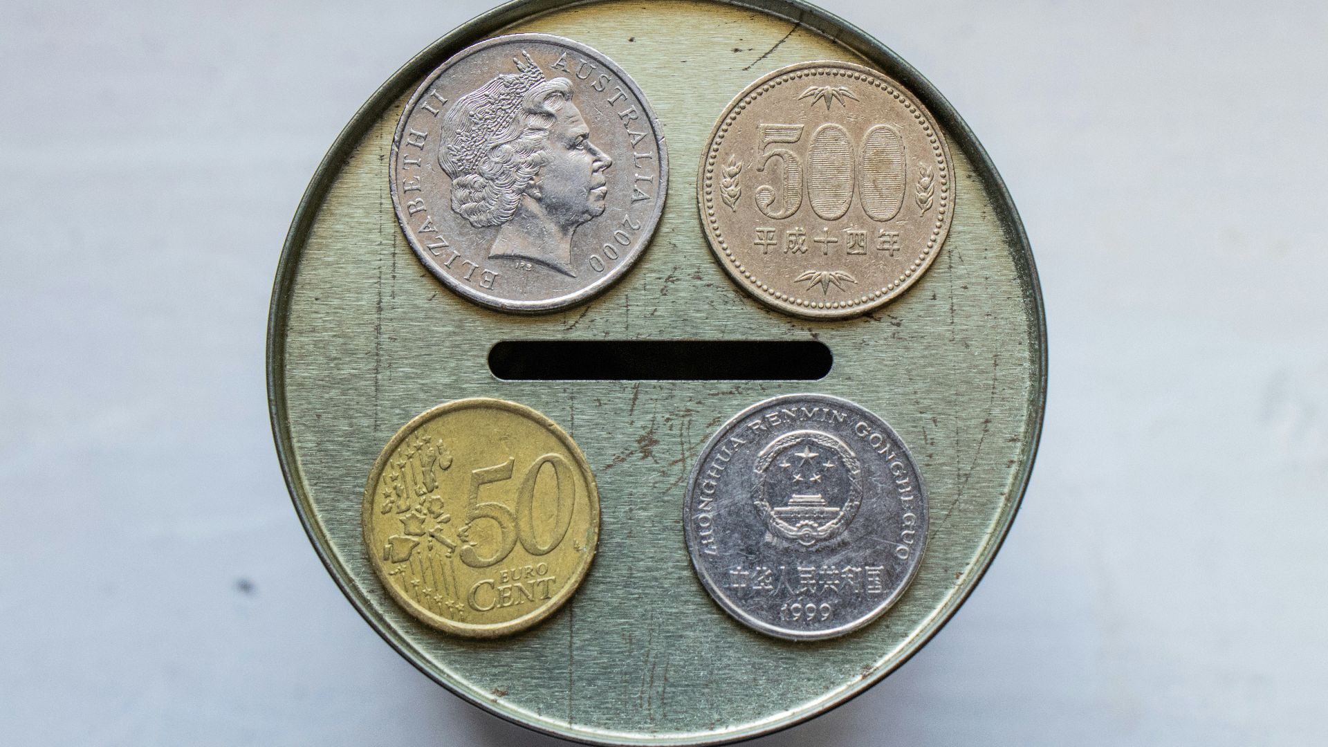 gold round coin on white surface