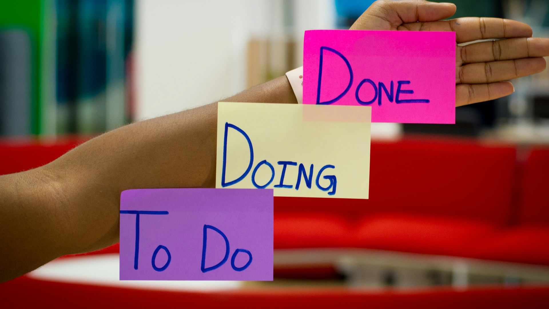 person holding purple and pink box