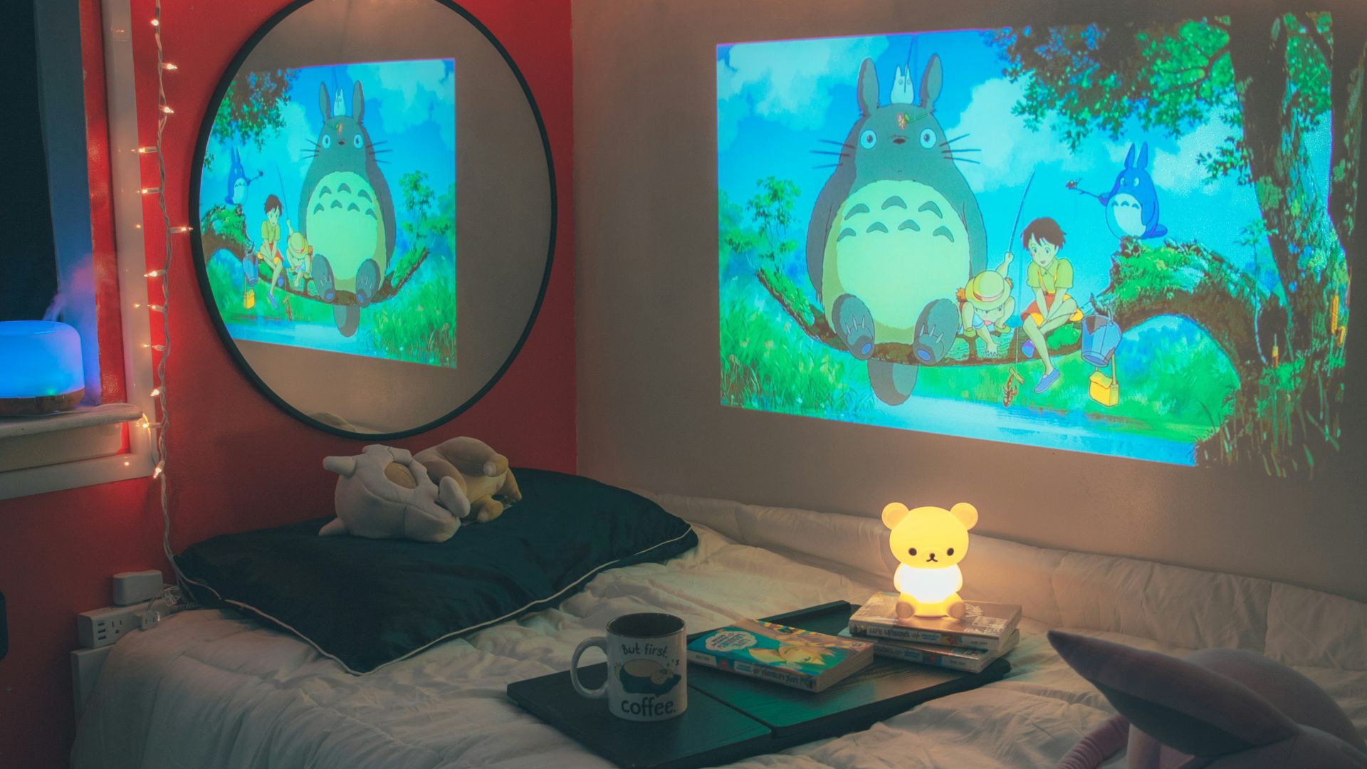 A room with a bed and two monitors on the wall