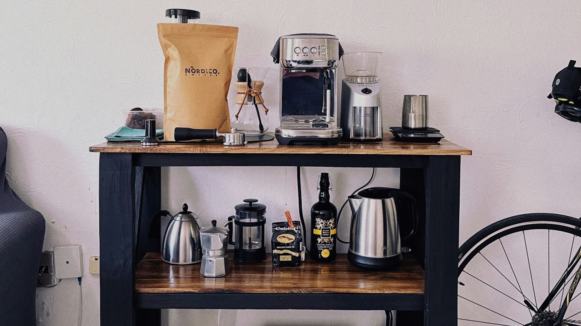 a table with a coffee maker, coffee pot, and other items on it