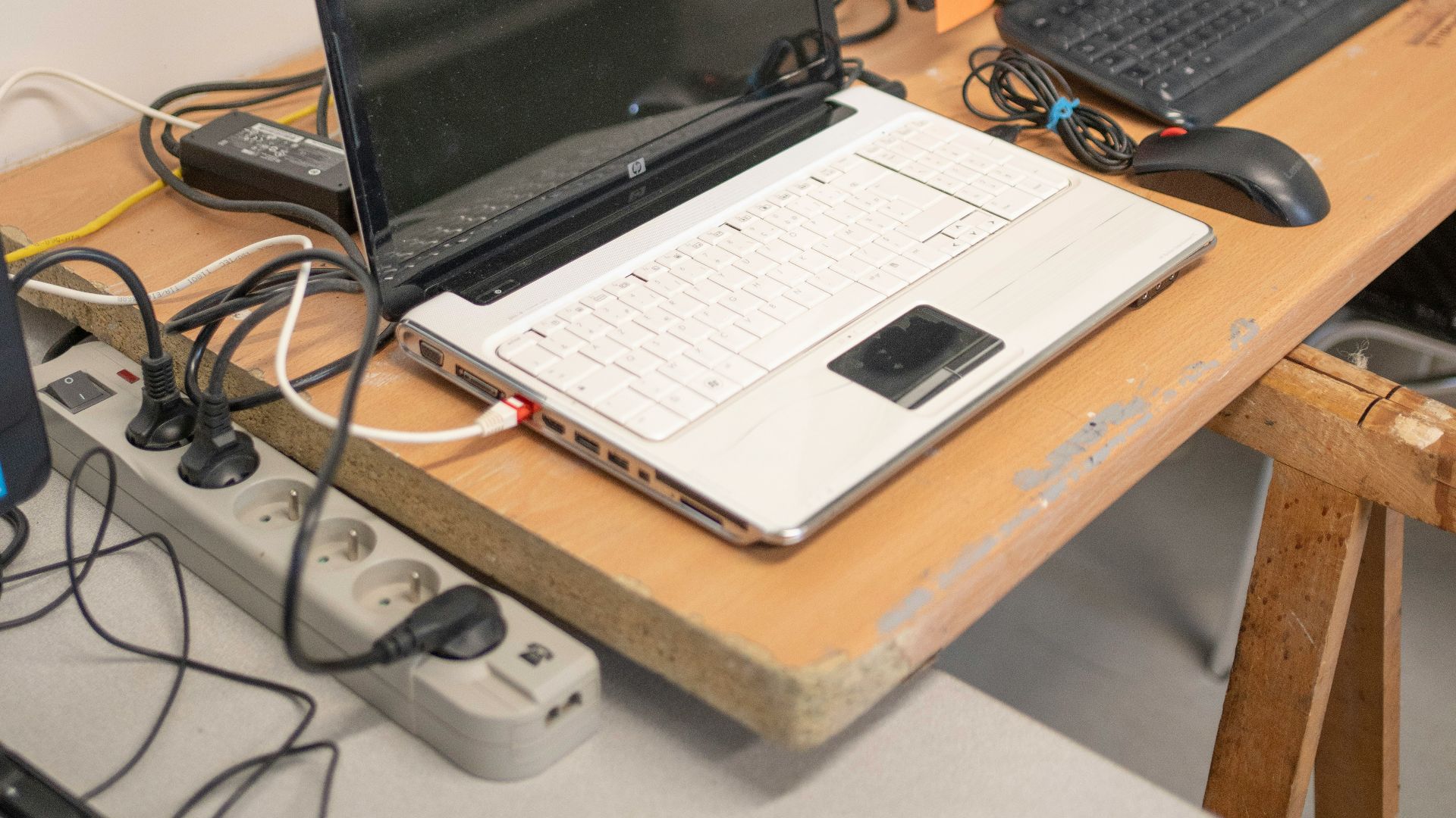a desk with two laptops and a keyboard on it