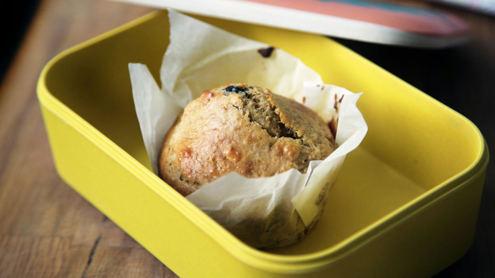 muffin on yellow plastic container
