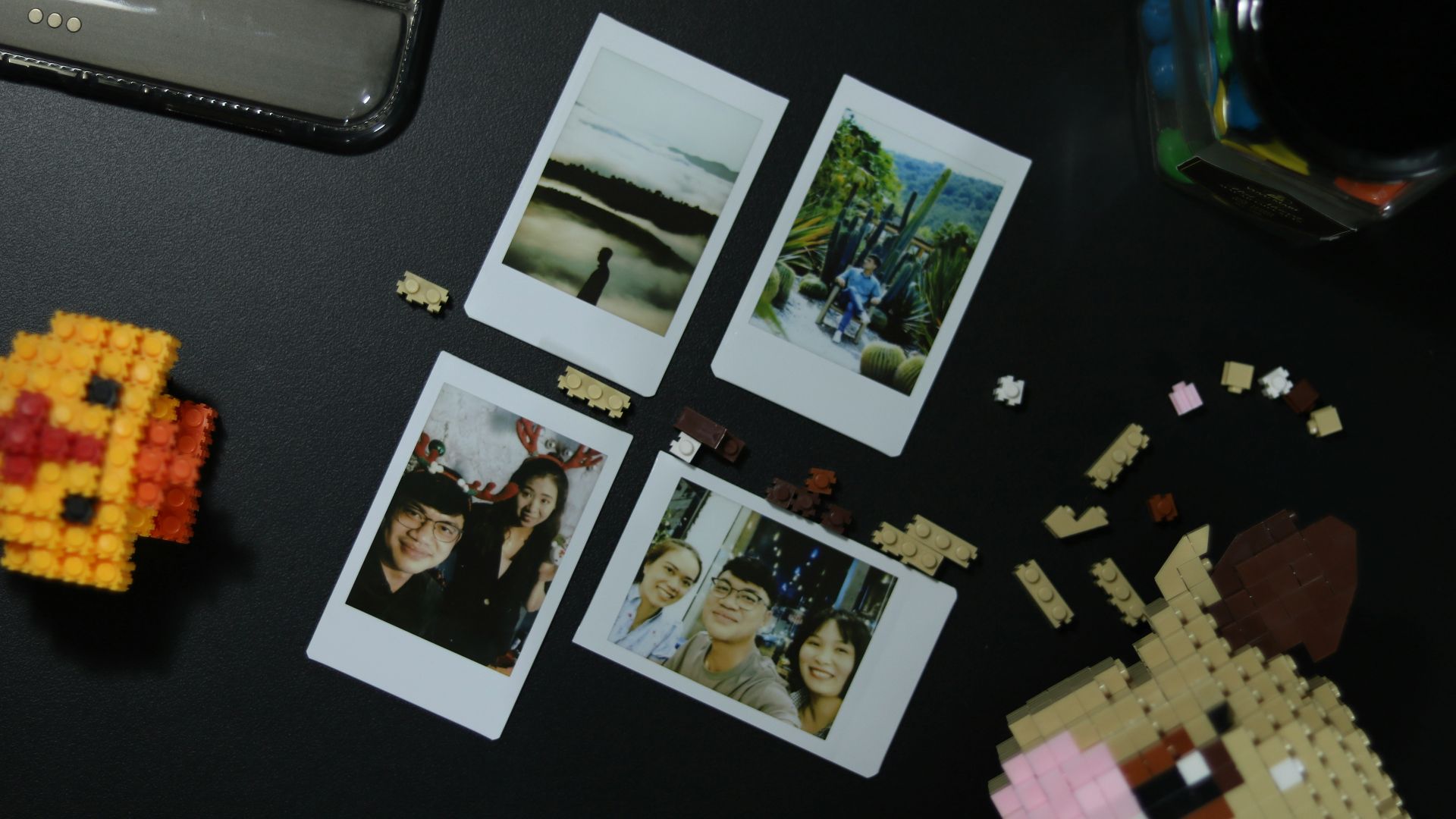 a black table topped with pictures of people and legos