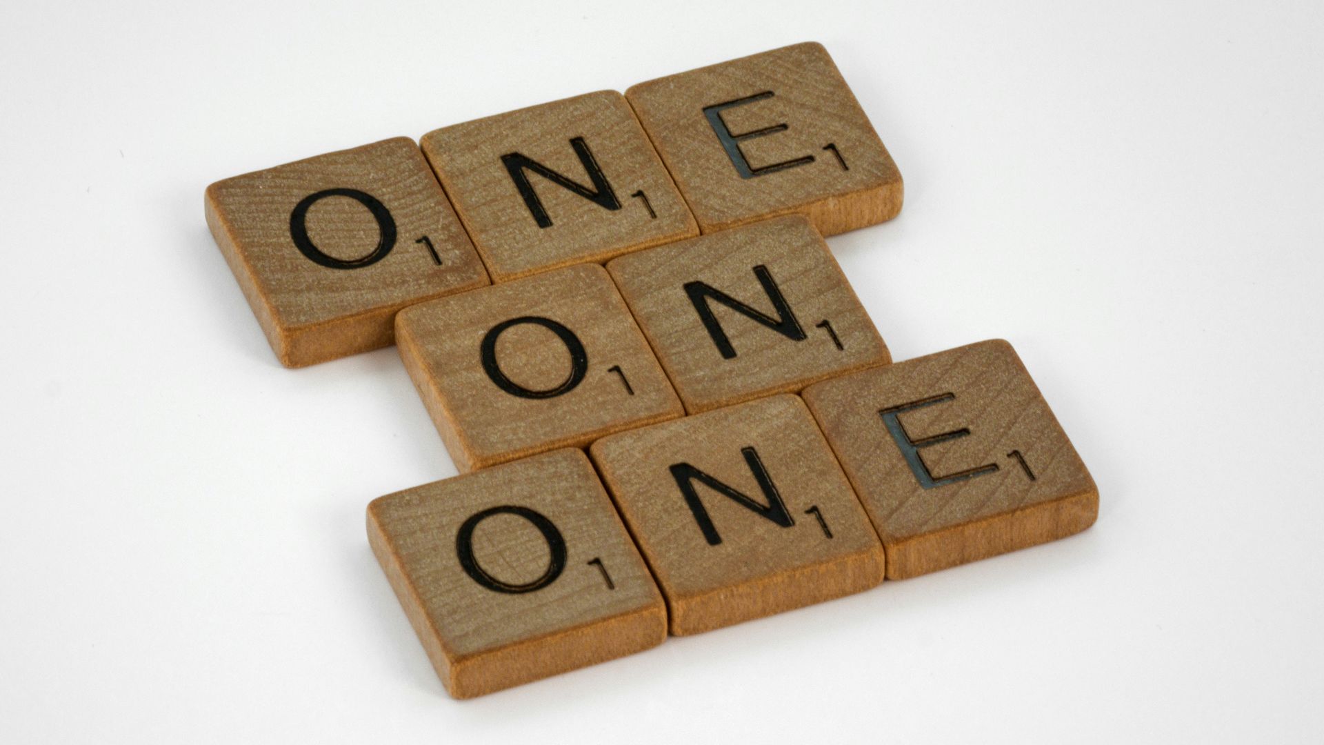 brown wooden letter blocks on white surface