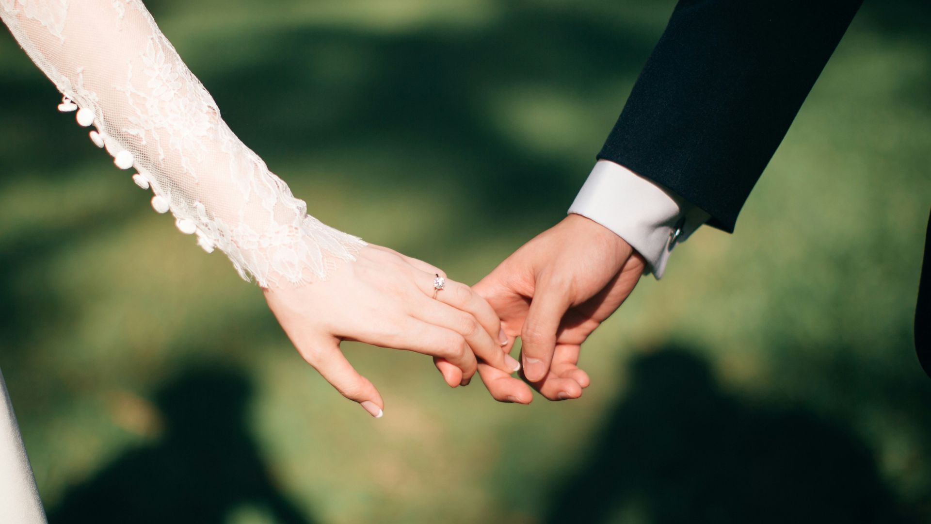 man and woman holding hands focus photo