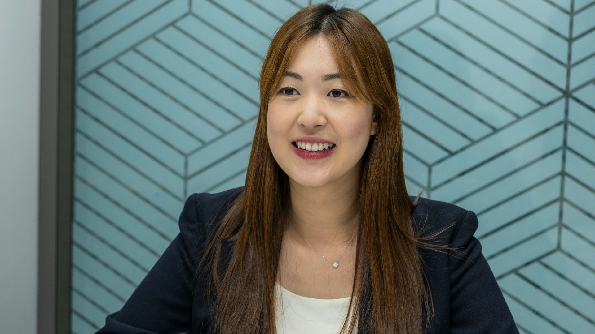 a woman sitting at a table with a piece of paper in front of her