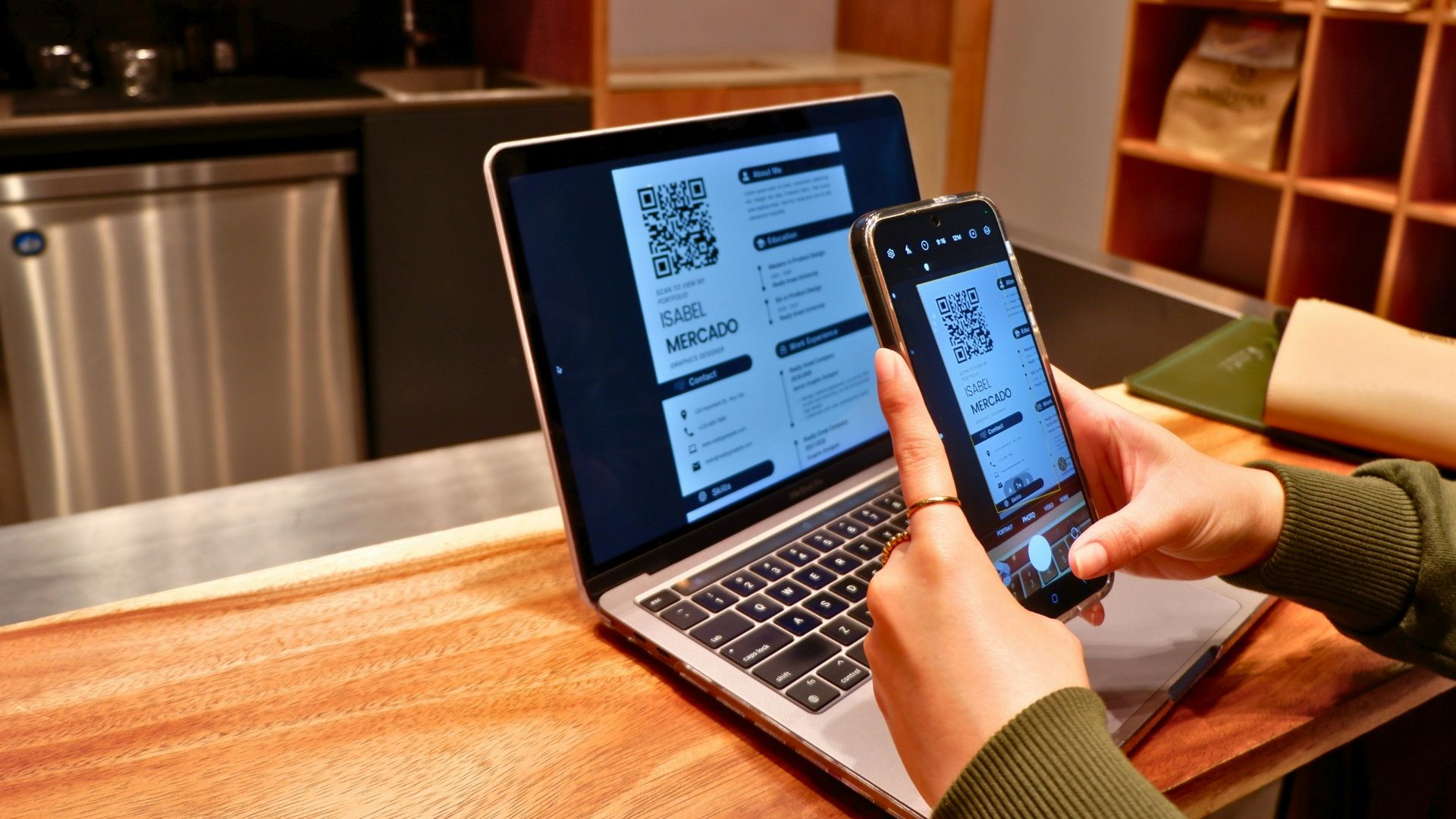 a person using a laptop and a cell phone