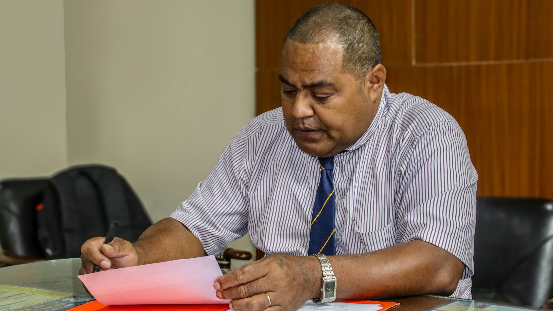 a man sitting at a table with papers in front of him