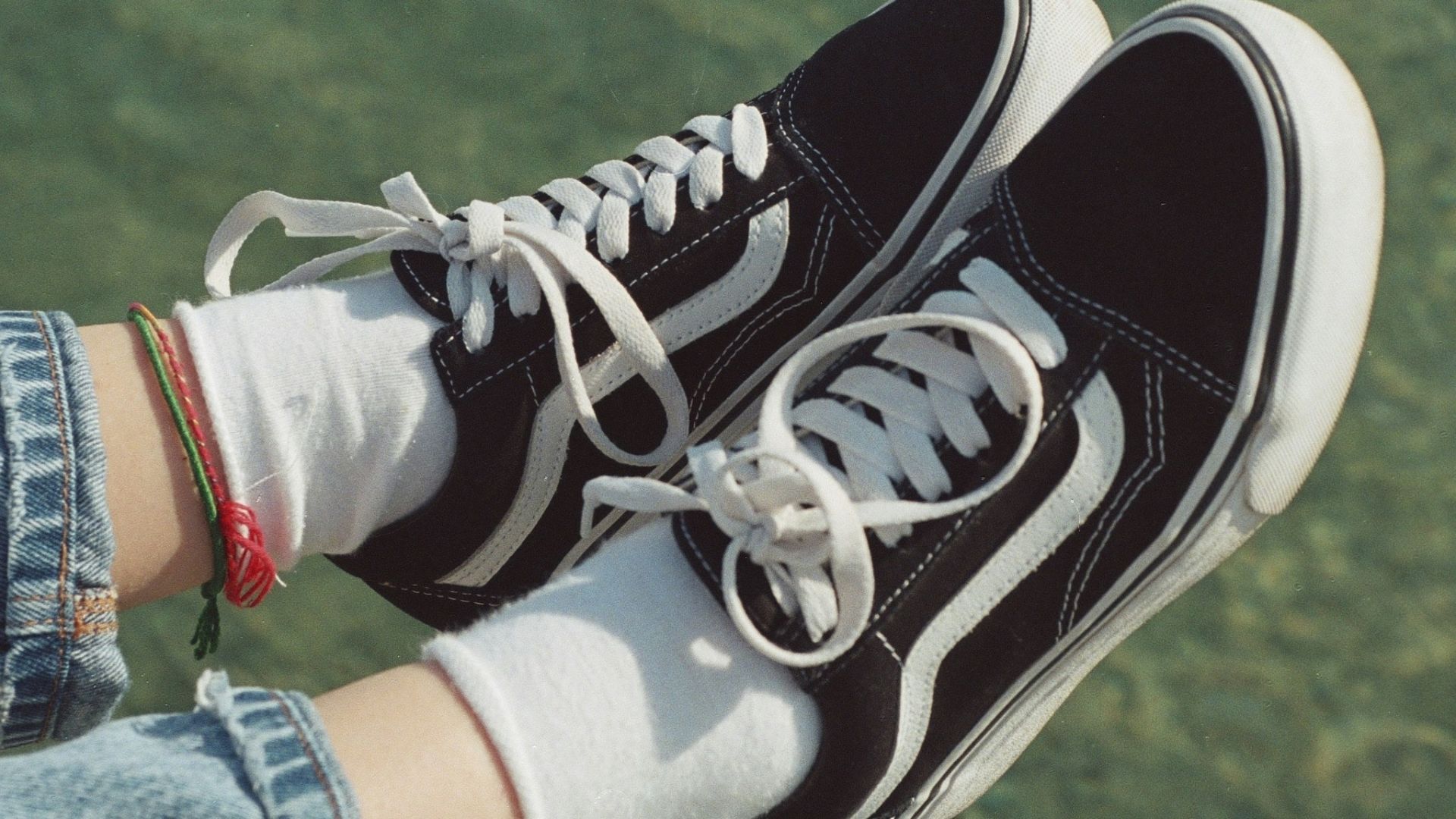 a person's feet in a pair of black and white sneakers