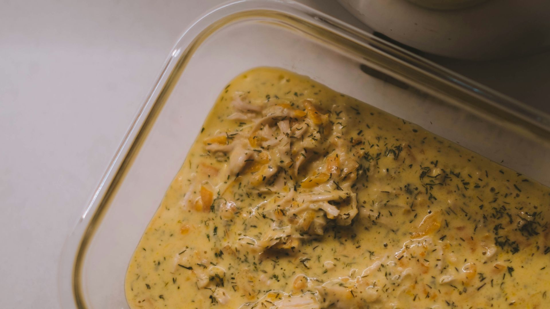 white plastic container with brown food