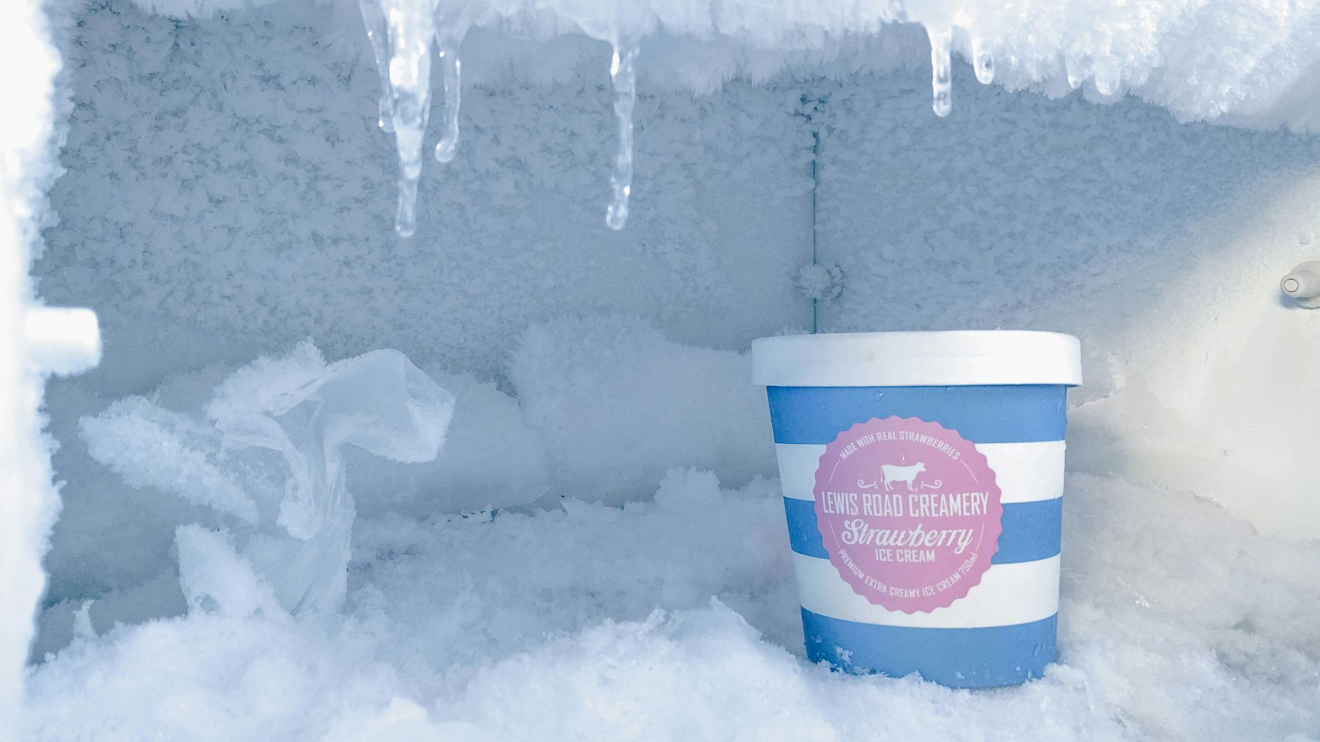 strawberry ice cream bottle inside container covered in ice