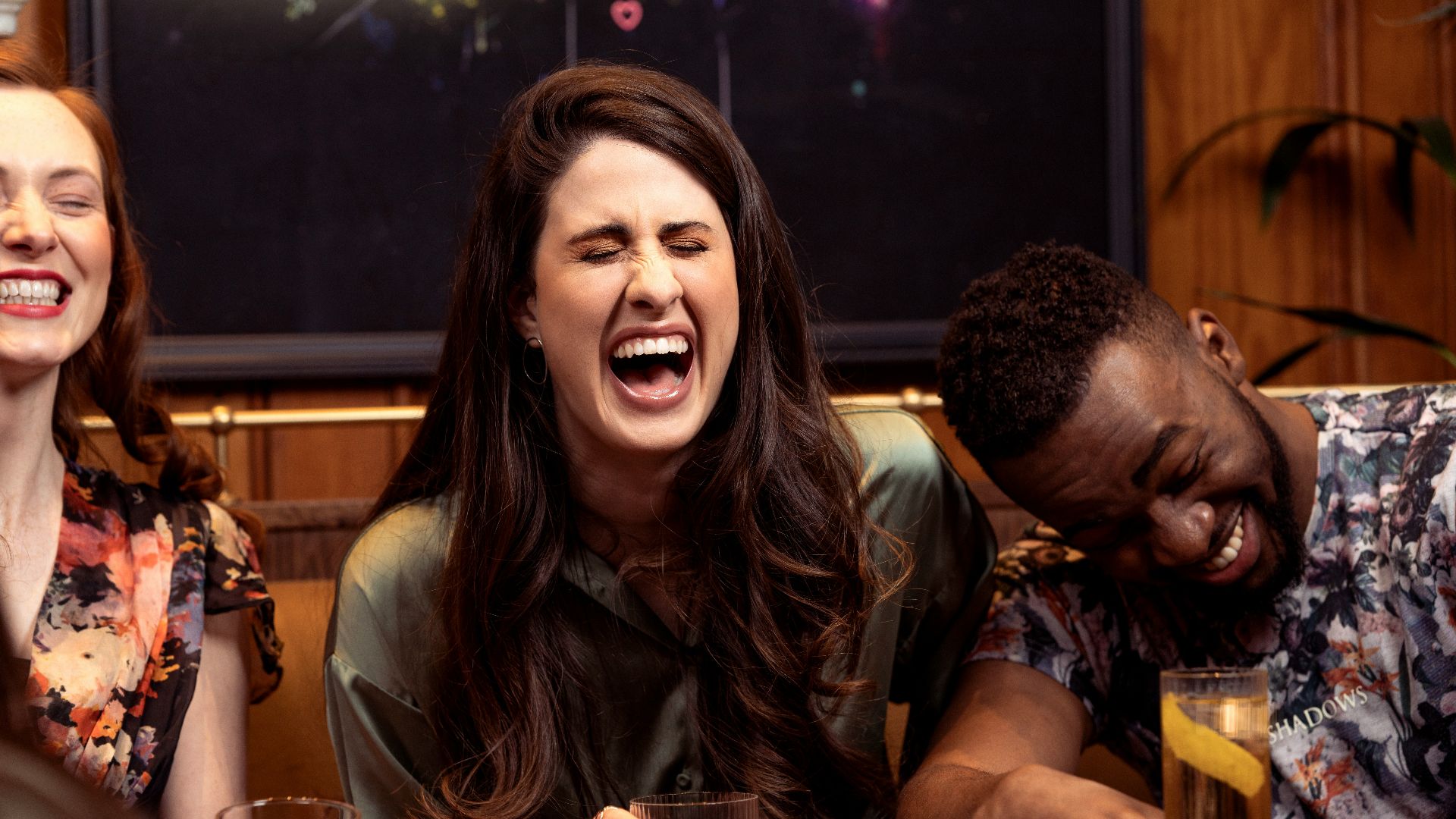 a group of people sitting around a table with drinks