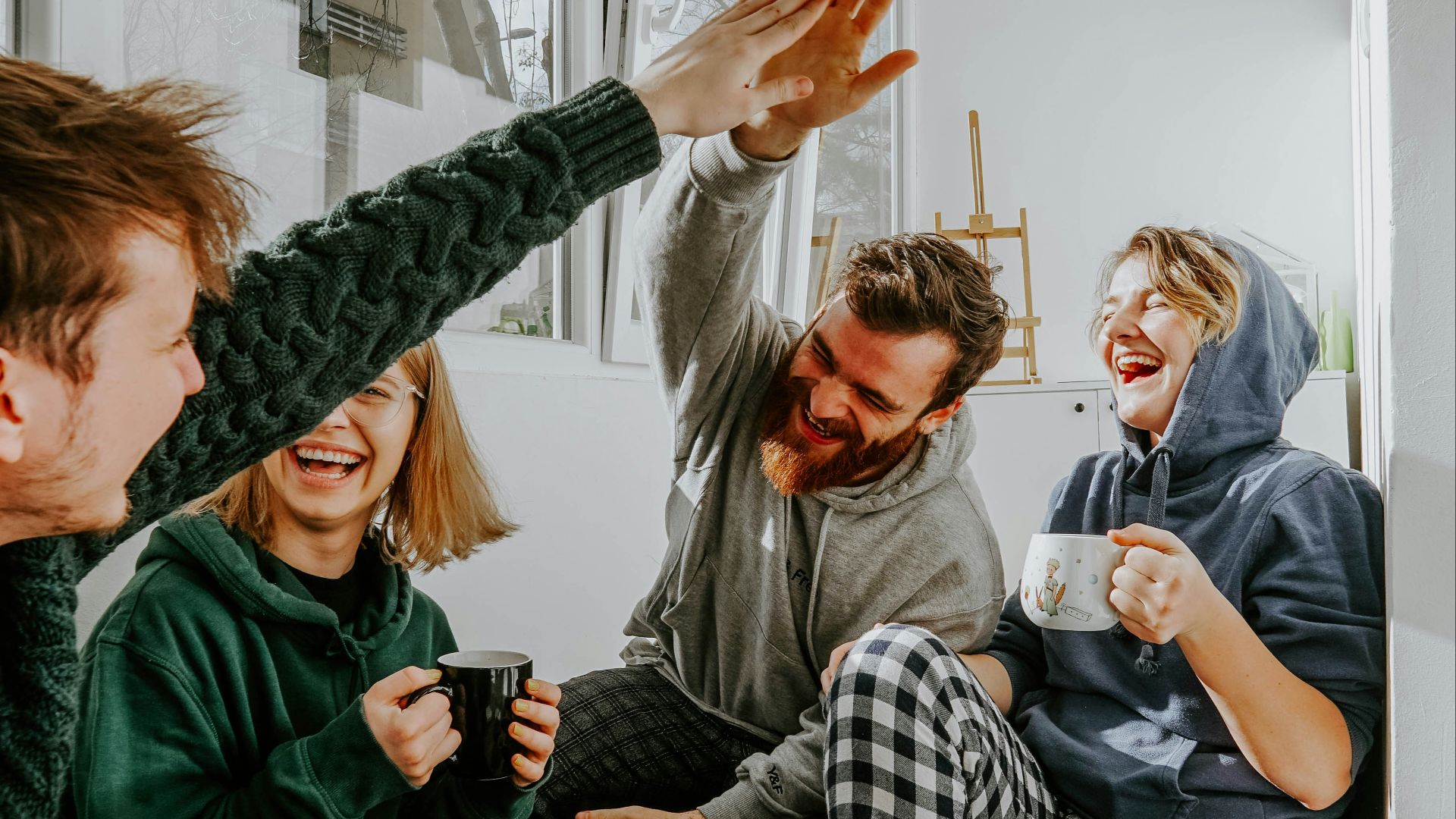 woman in black and white checkered long sleeve shirt sitting beside man in green crew neck