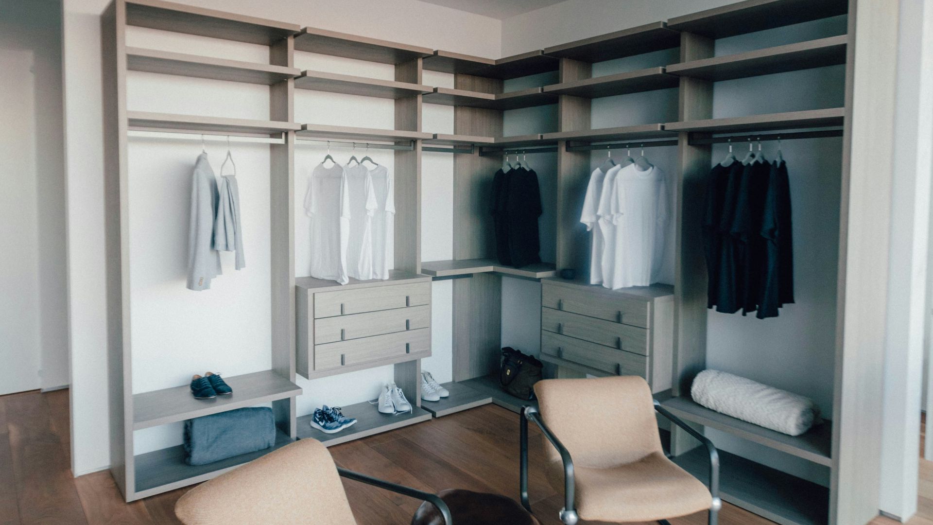 two black metal framed beige padded chair with round coffee table