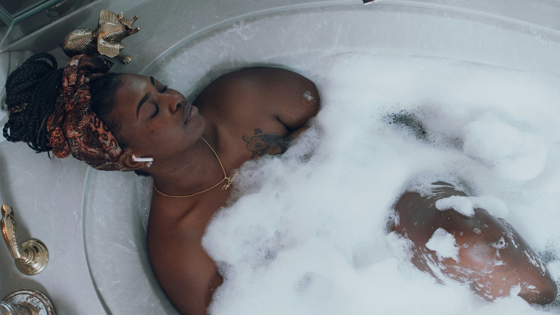woman in white bathtub with water