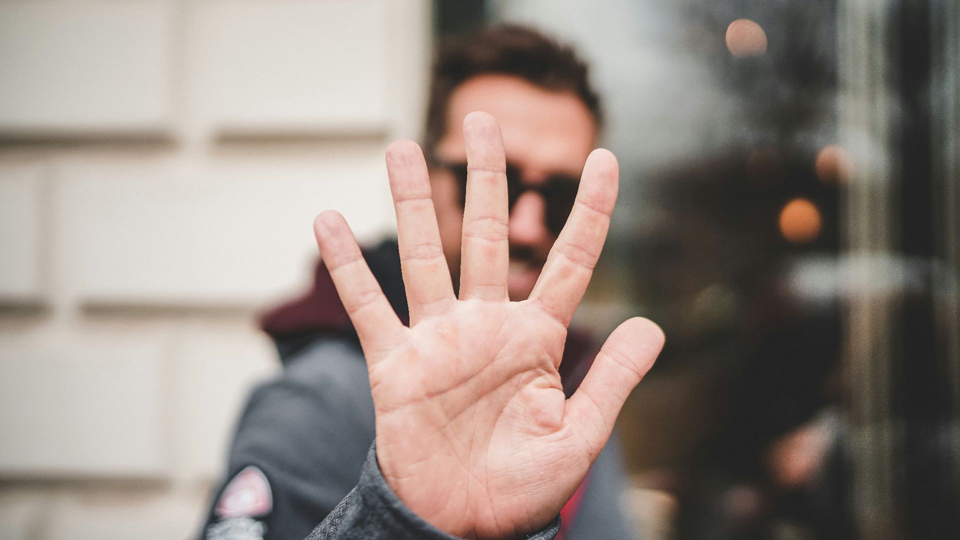 man raising right hand