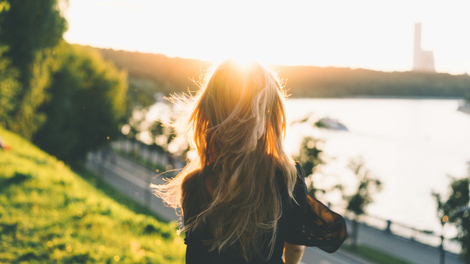 woman sitting while looking at the sunset