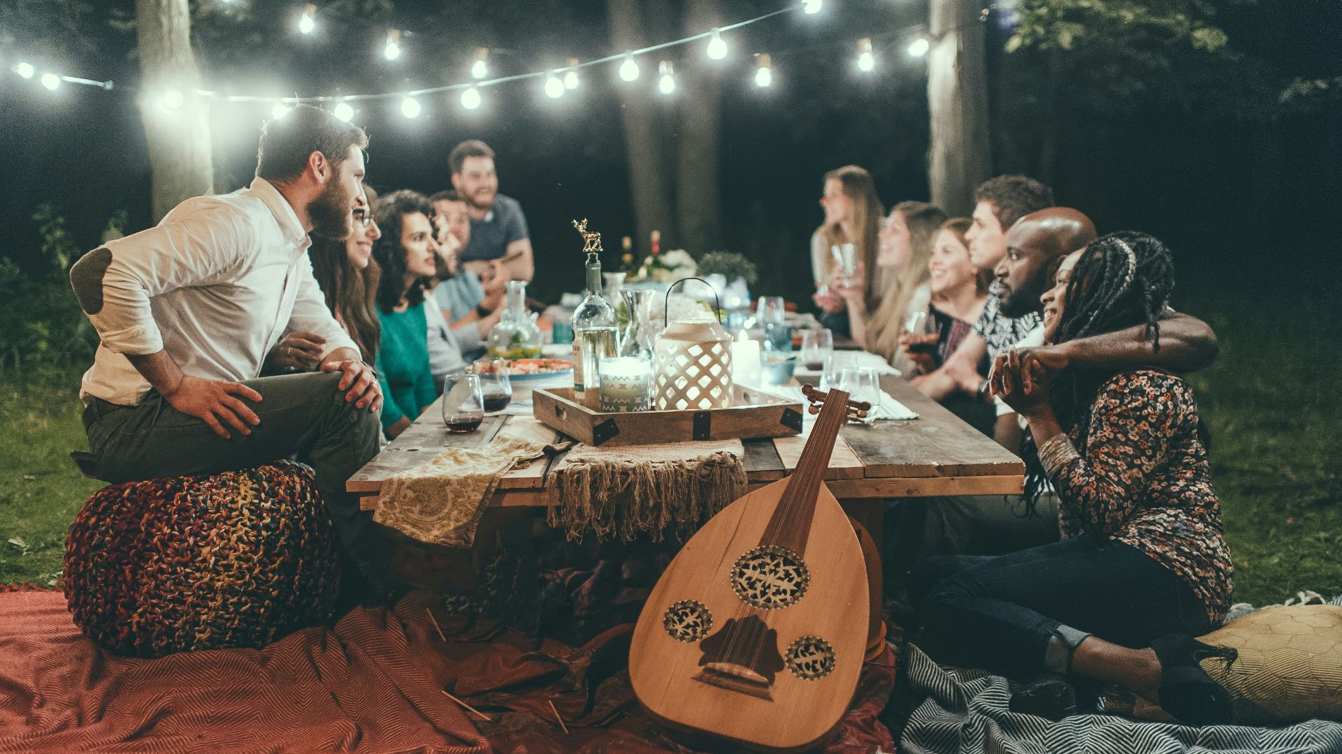 people sitting on chair in front of table with candles and candles